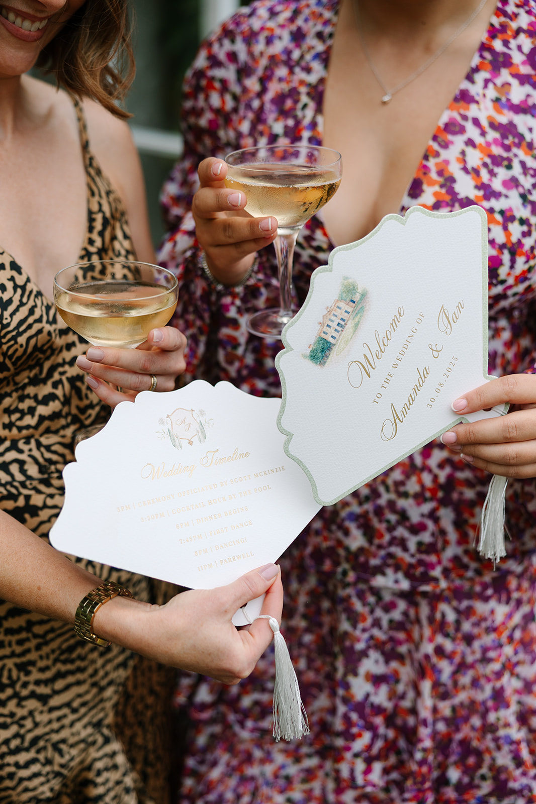 Fan shaped paper wedding timelines and programs with tassels and venue watercolor illustration