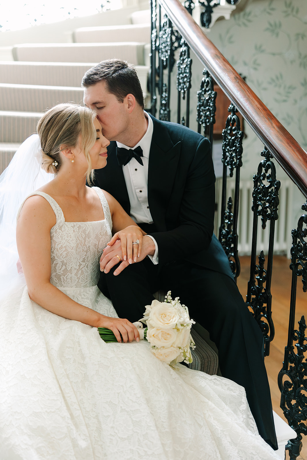 Bride and groom sitting on stairs in Findon Place