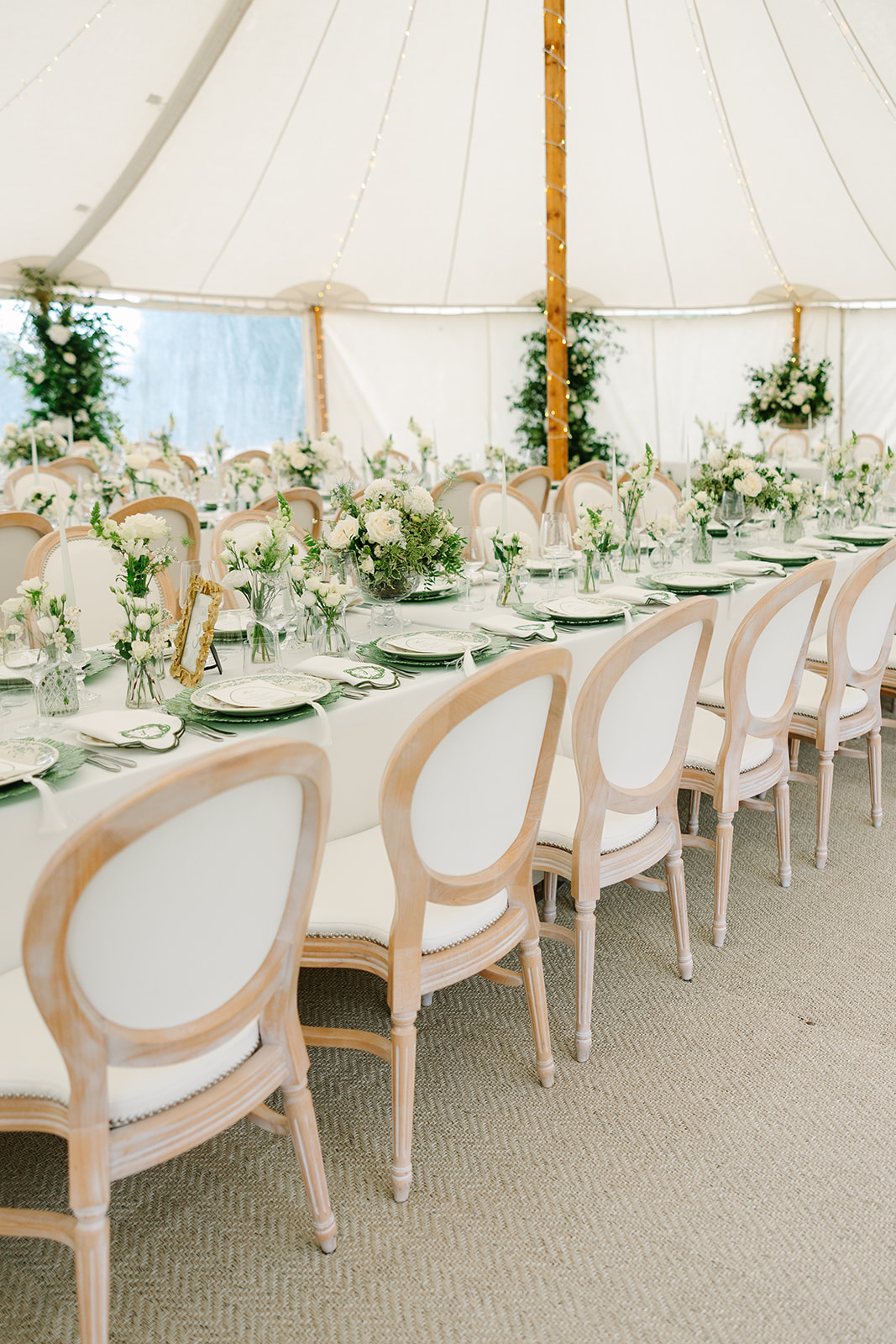 Roundback cushioned chairs for marquee wedding setup
