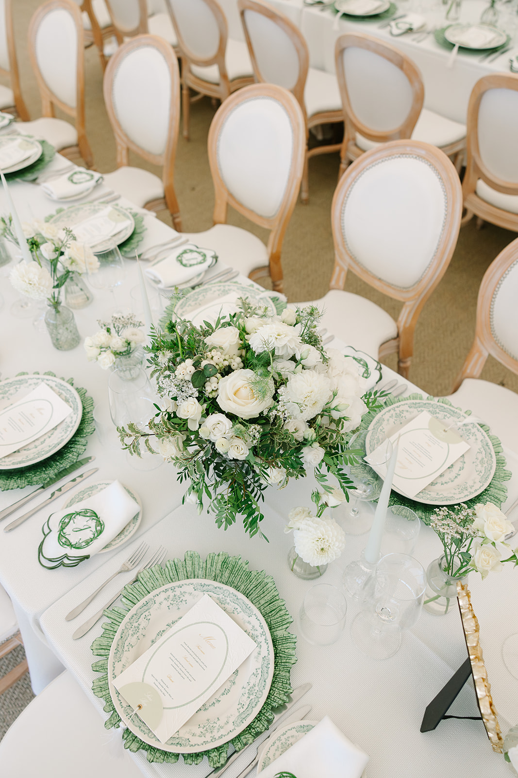 Green and white wedding reception table decor ideas with embroidered monogram napkins and tassel menu cards