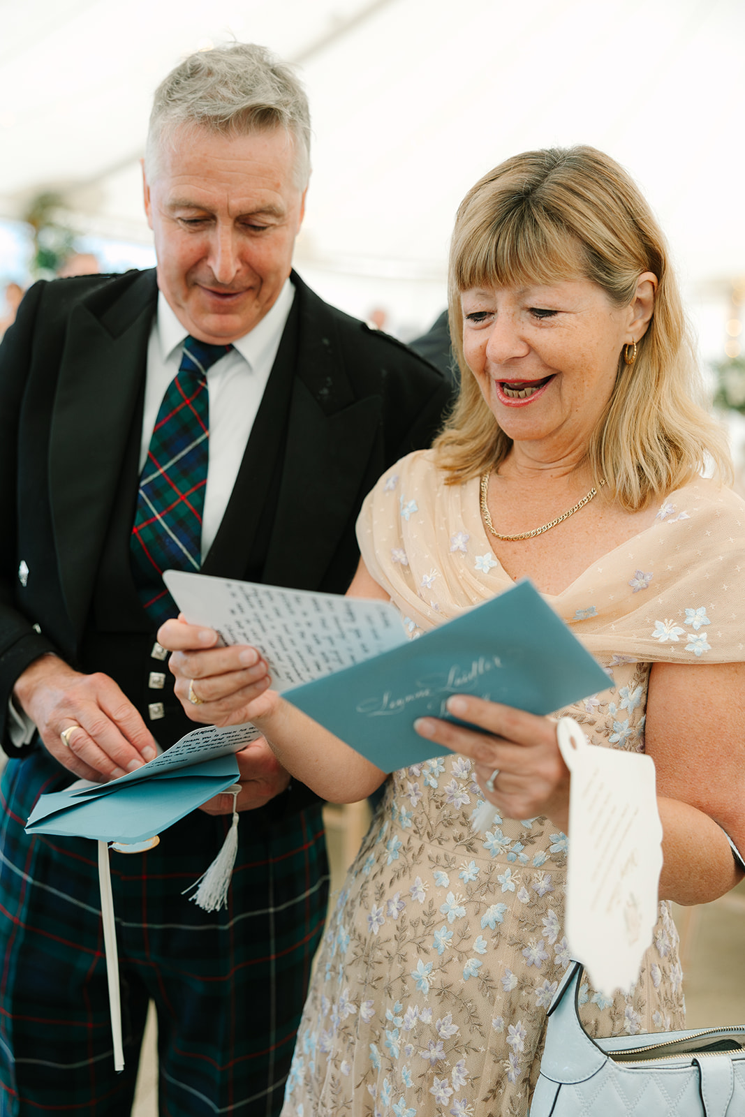 Wedding guests reading their personal notes from bride and groom