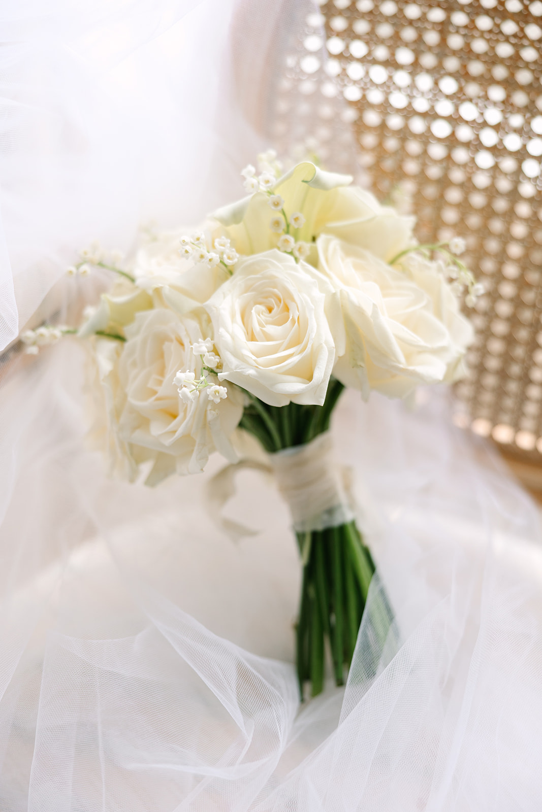 Simple bridal bouquet with white roses and lily of the valley for classic wedding