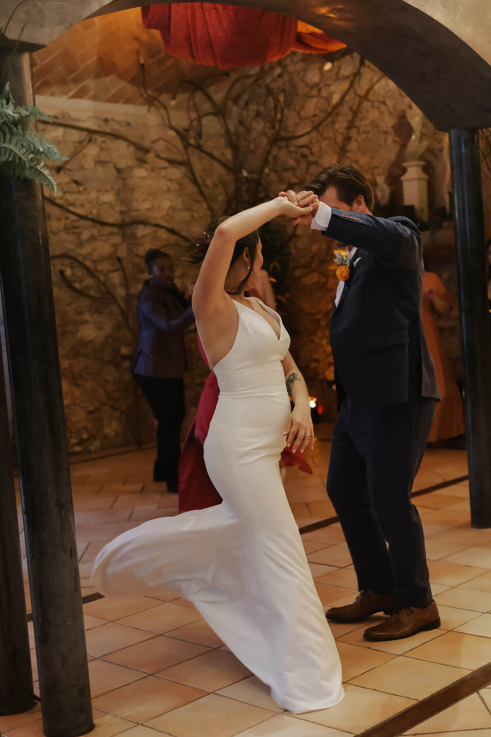 Bride and groom share their first dance together as the groom spins the bride