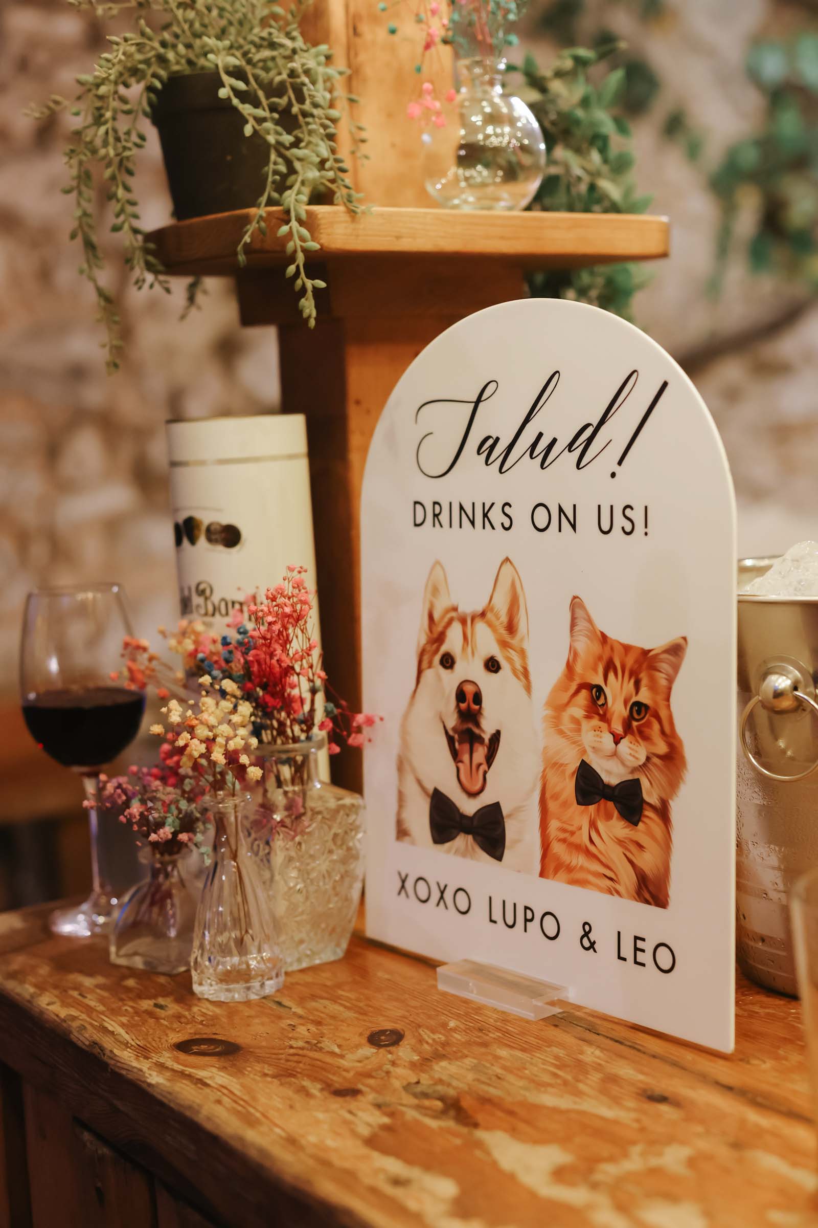 Arch shape wedding bar sign with the couple's husky dog and orange fluffy cat welcoming people to have free drinks