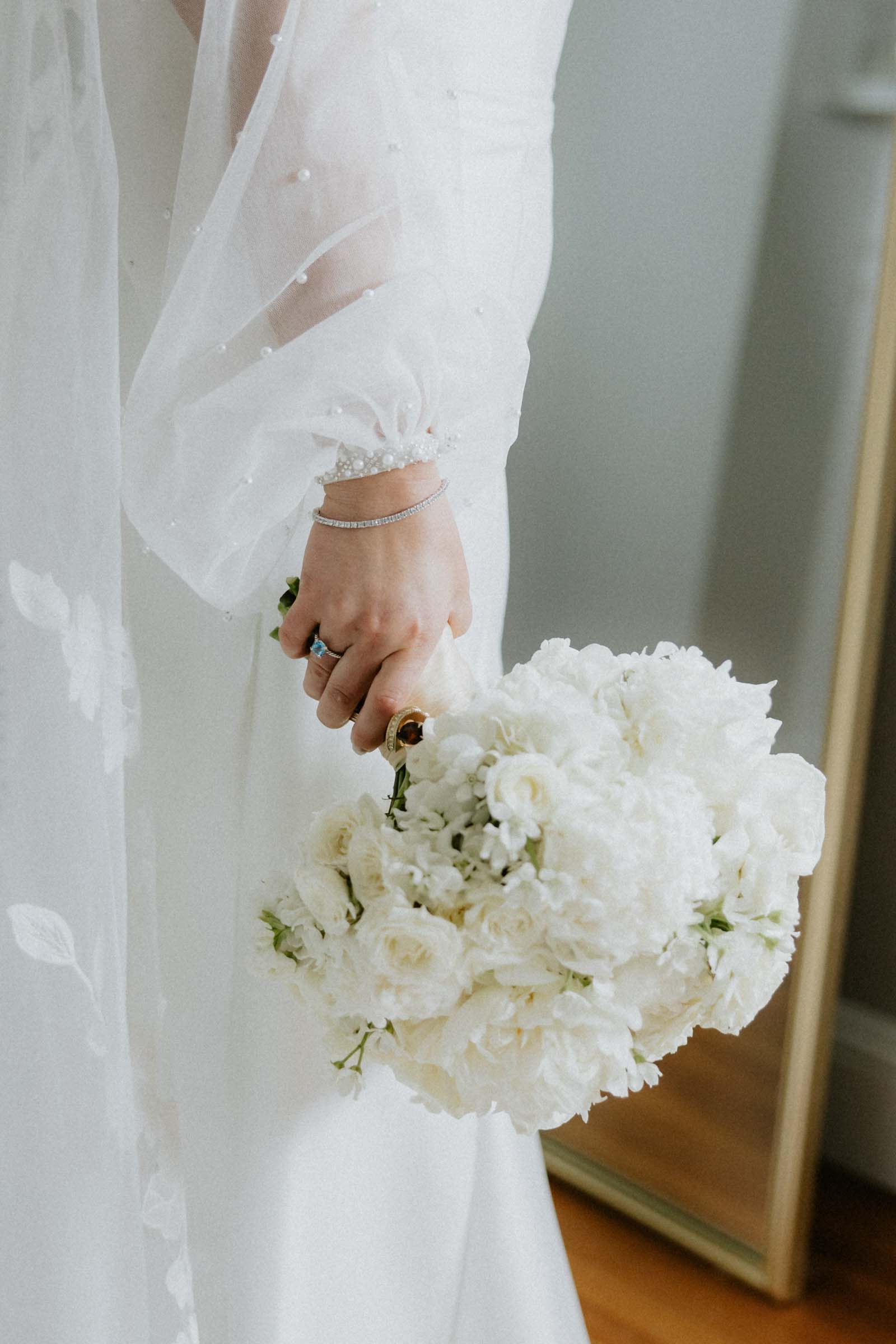 Bride wearing pearl sheer detachable balloon sleeves