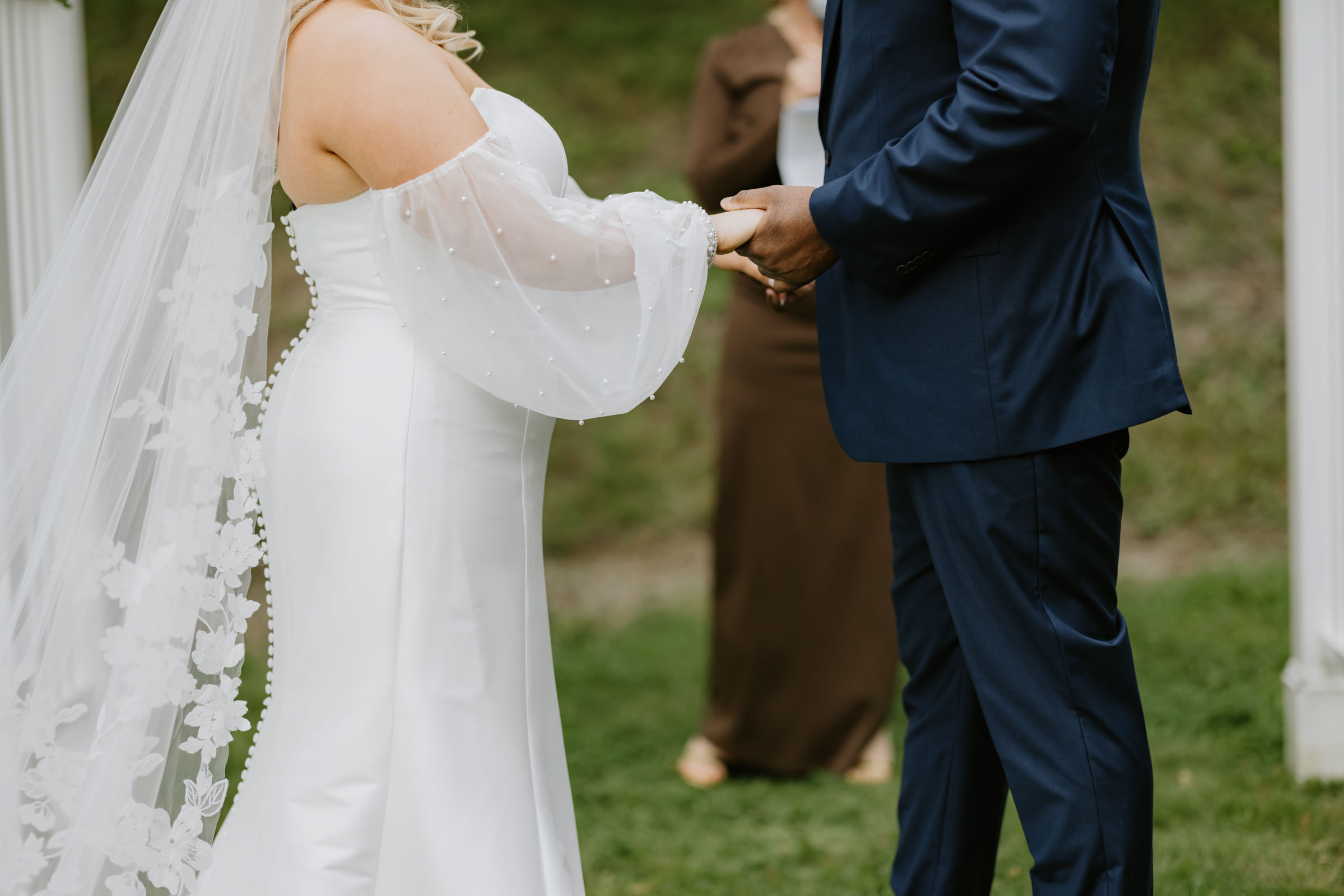 Bride wearing pearl beaded sheer chiffon detachable balloon sleeves with her strapless wedding dress
