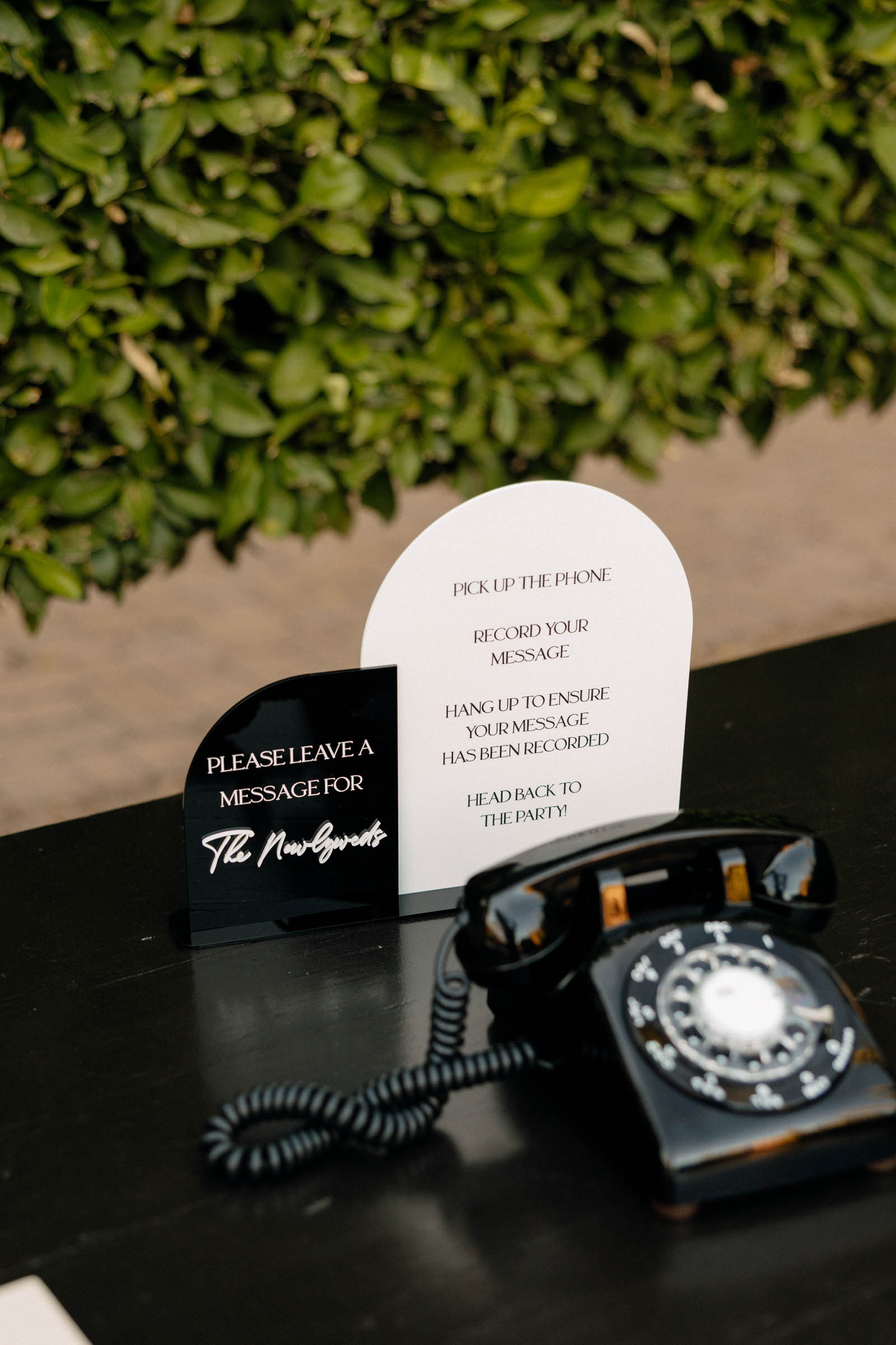 Modern black retro rotary phone for a wedding audio guestbook setup