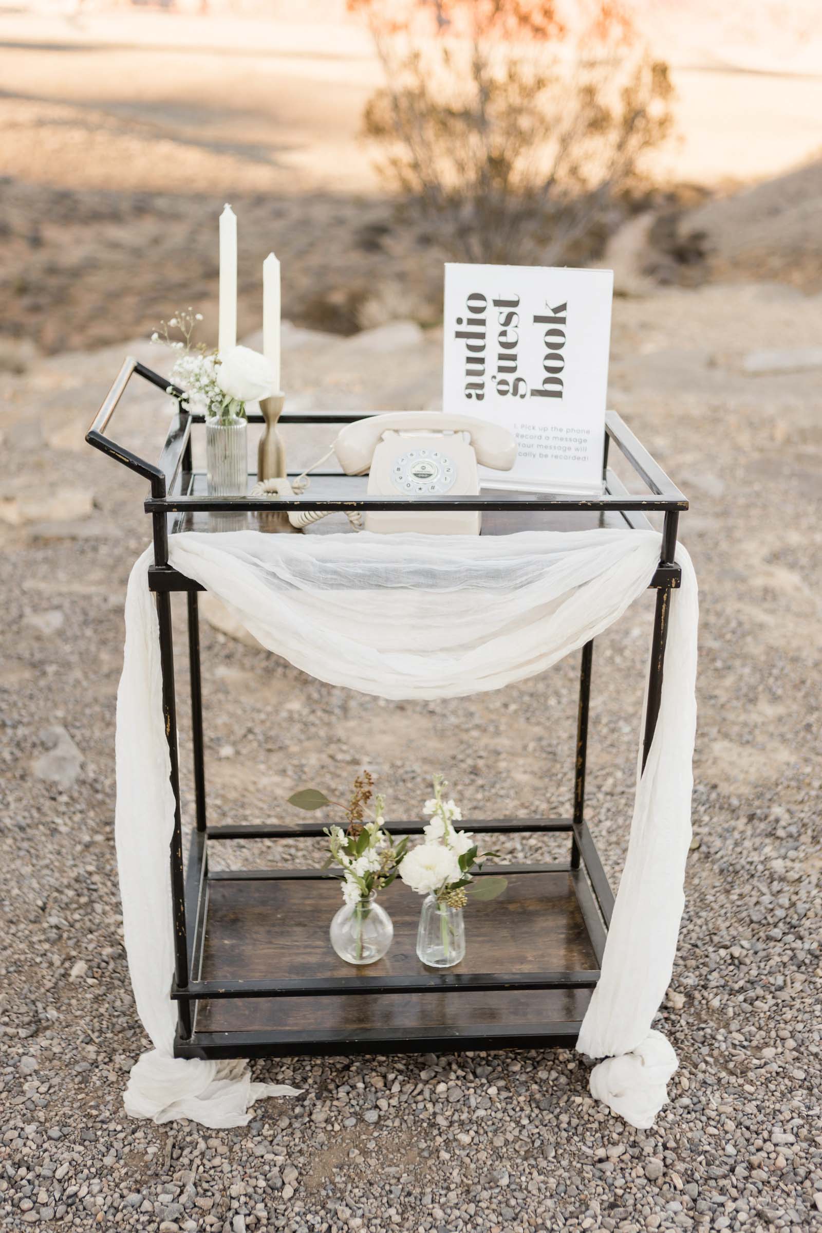 Modern white retro rotary phone for a wedding audio guestbook setup