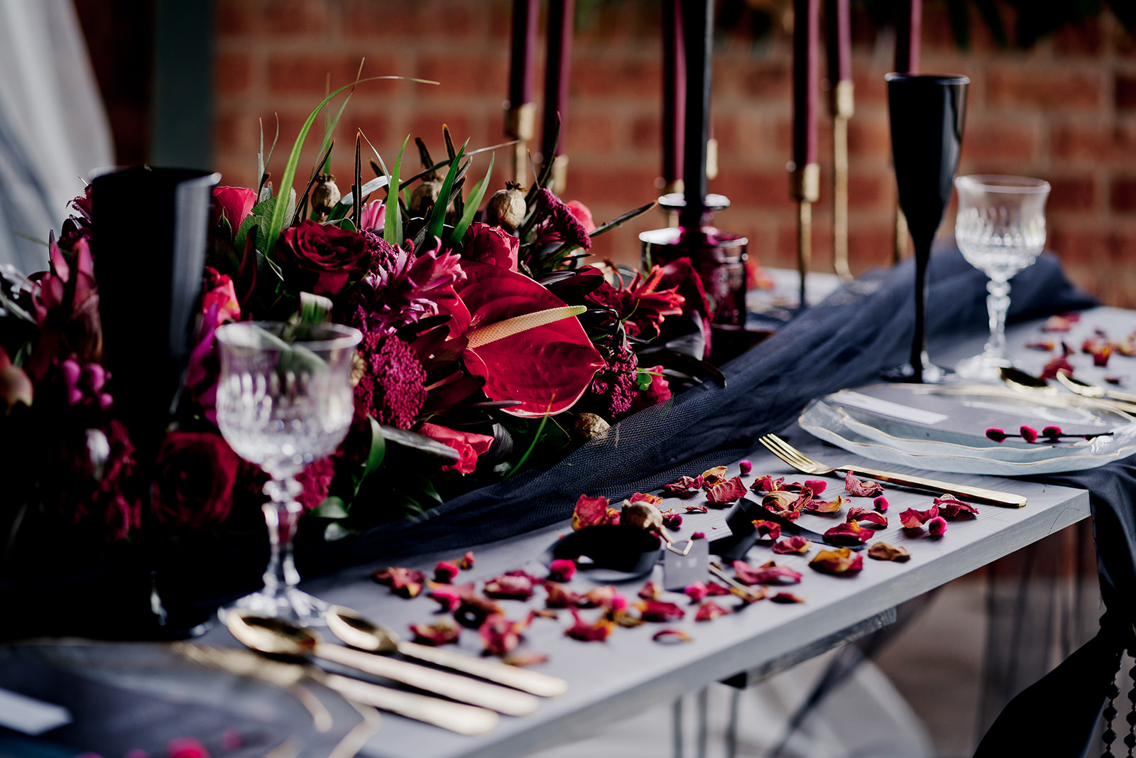 Black tulle wedding table runner for reception decor with pink Anthurium flower centerpiece