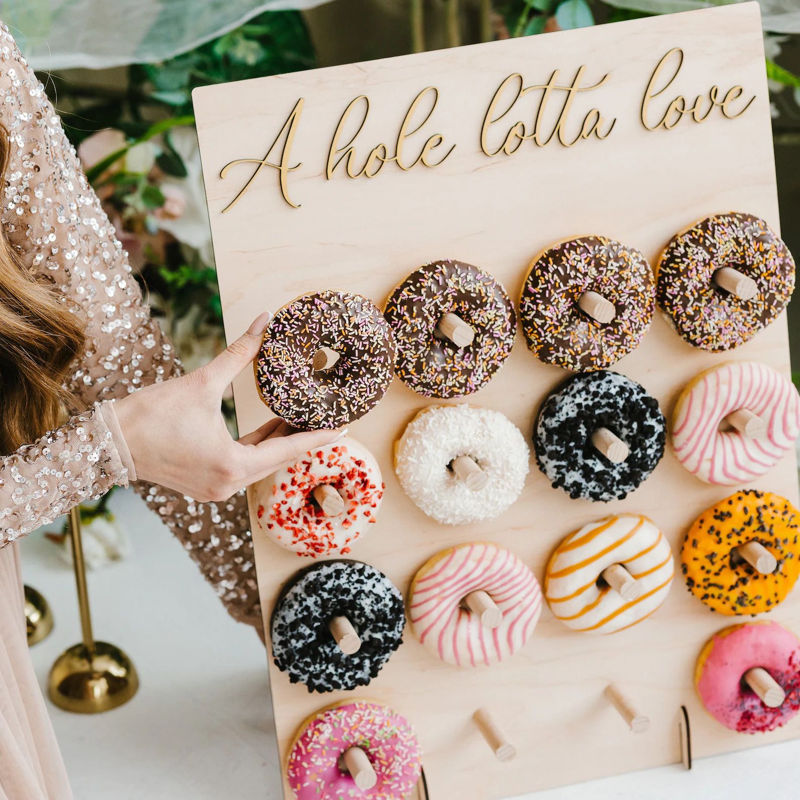 Wood tabletop donut wall with a Hole Lotta Love sign