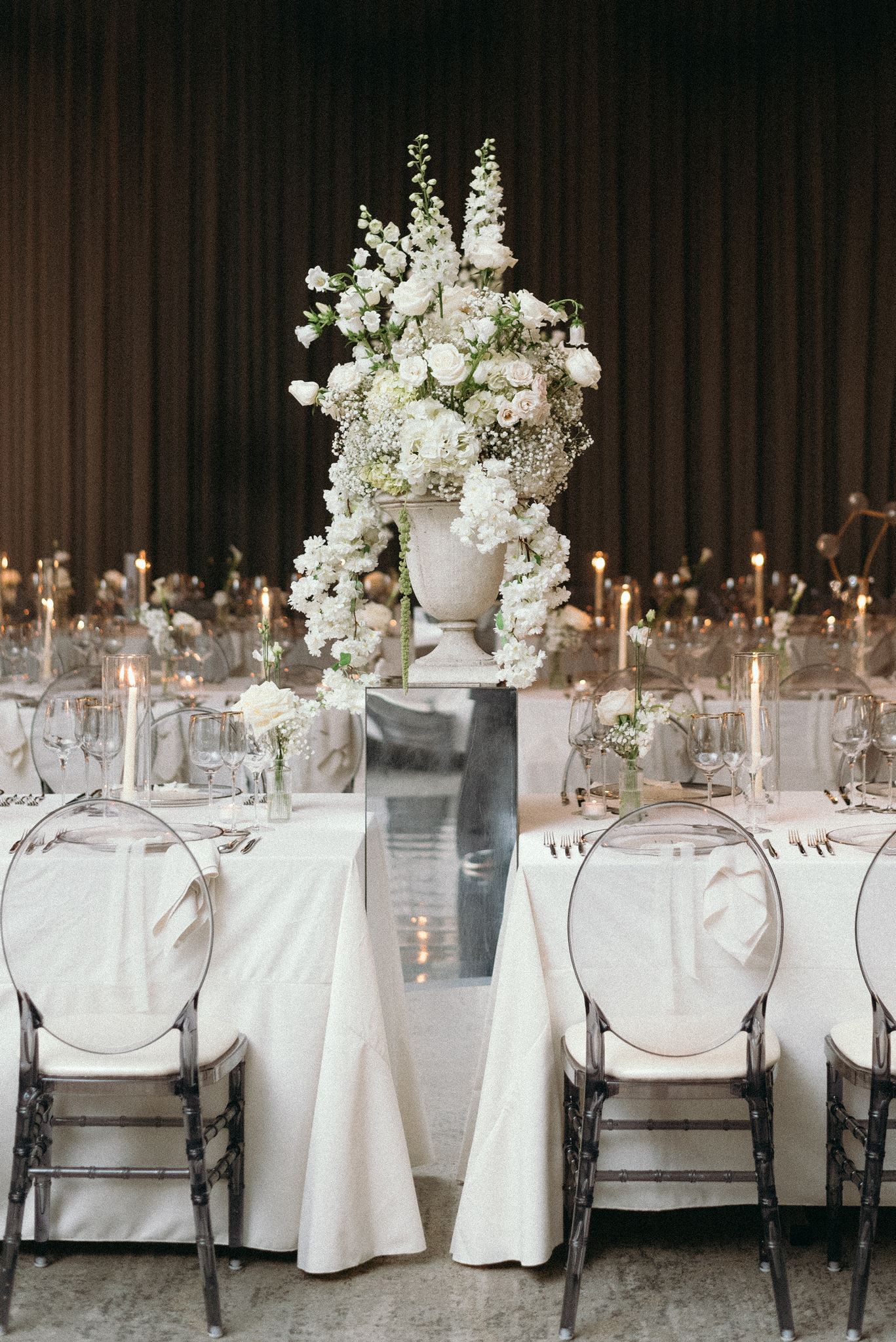 Mirror riser display with statement florals for wedding reception idea