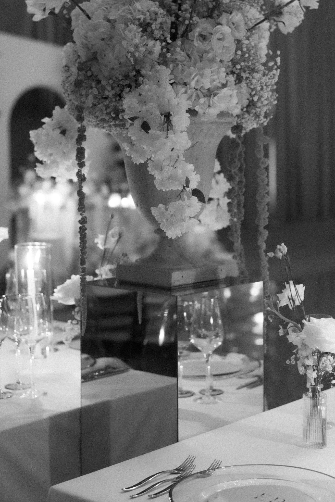 Mirror riser display with statement florals for wedding reception idea