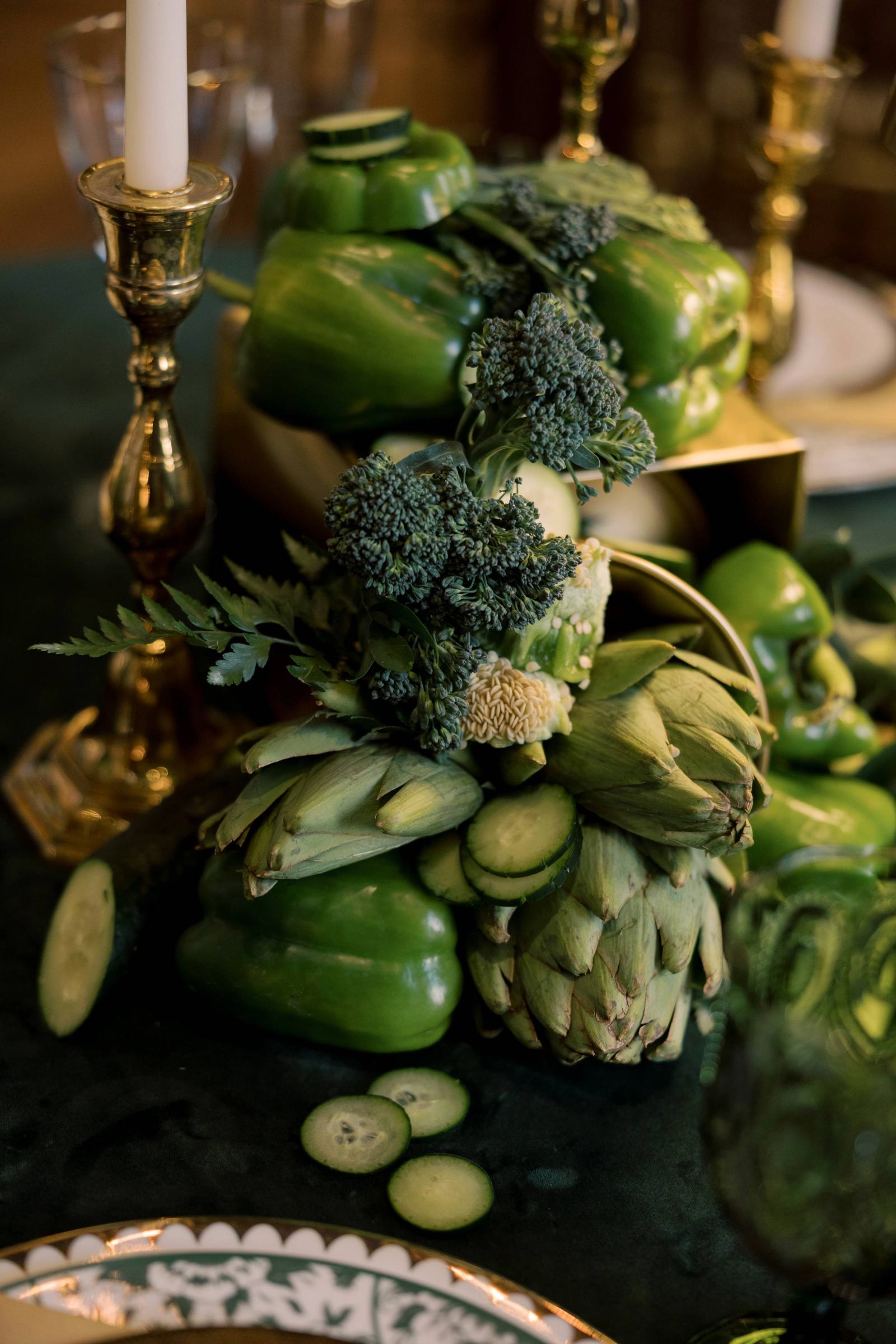 All green vegetable wedding table decor with peppers, cucumbers, artichokes, and broccoli