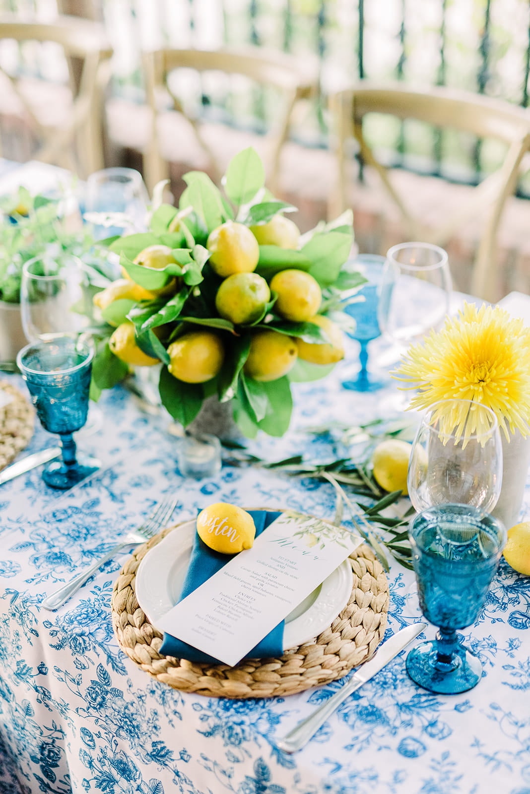 Lemon fruits and pots of basil for fresh summery edible citrus wedding table decor idea with lemons personalized with Cricut vinyl for place cards