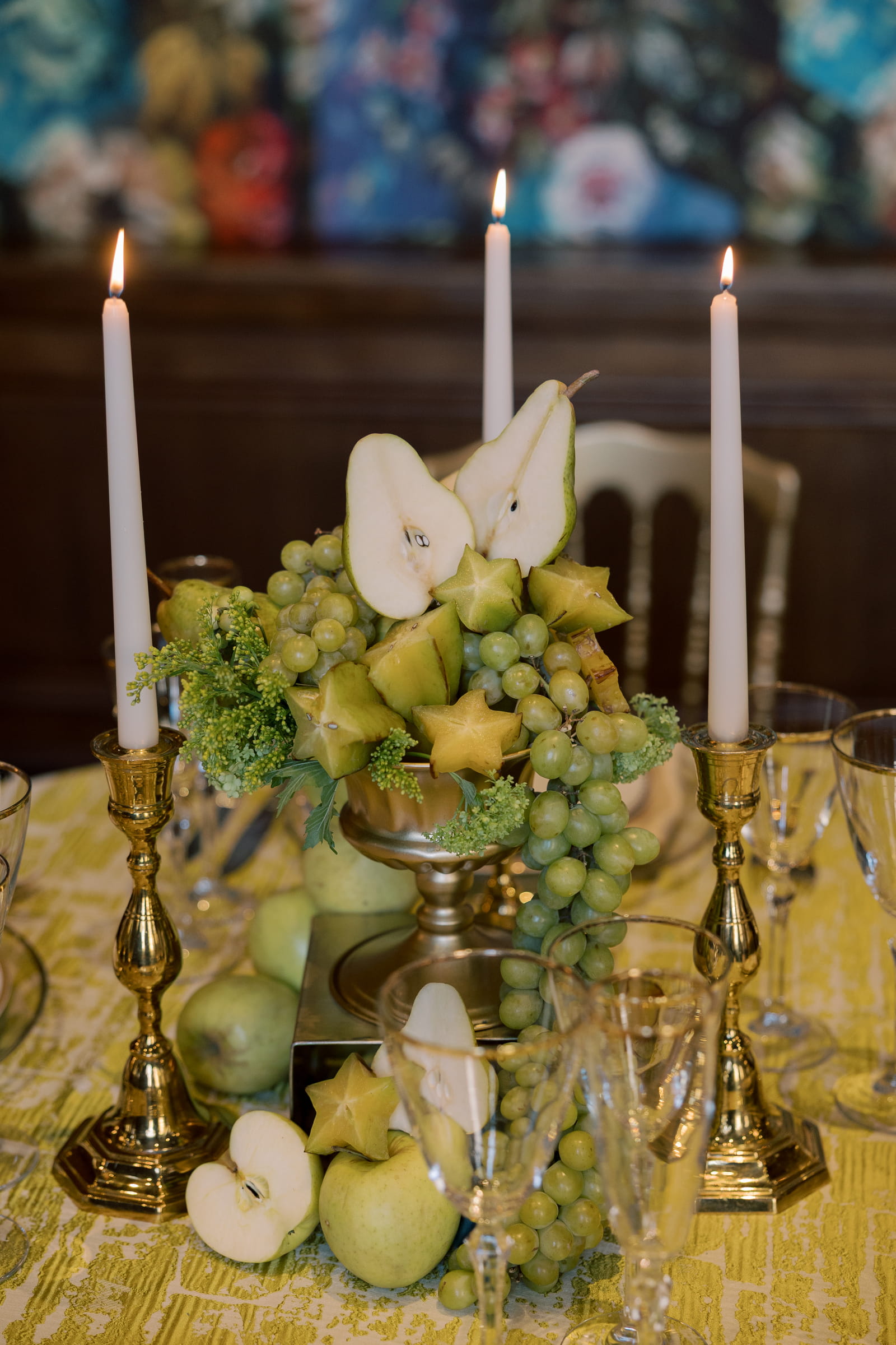 All green fruit wedding table decor with green flowers, pears, grapes, and star fruit