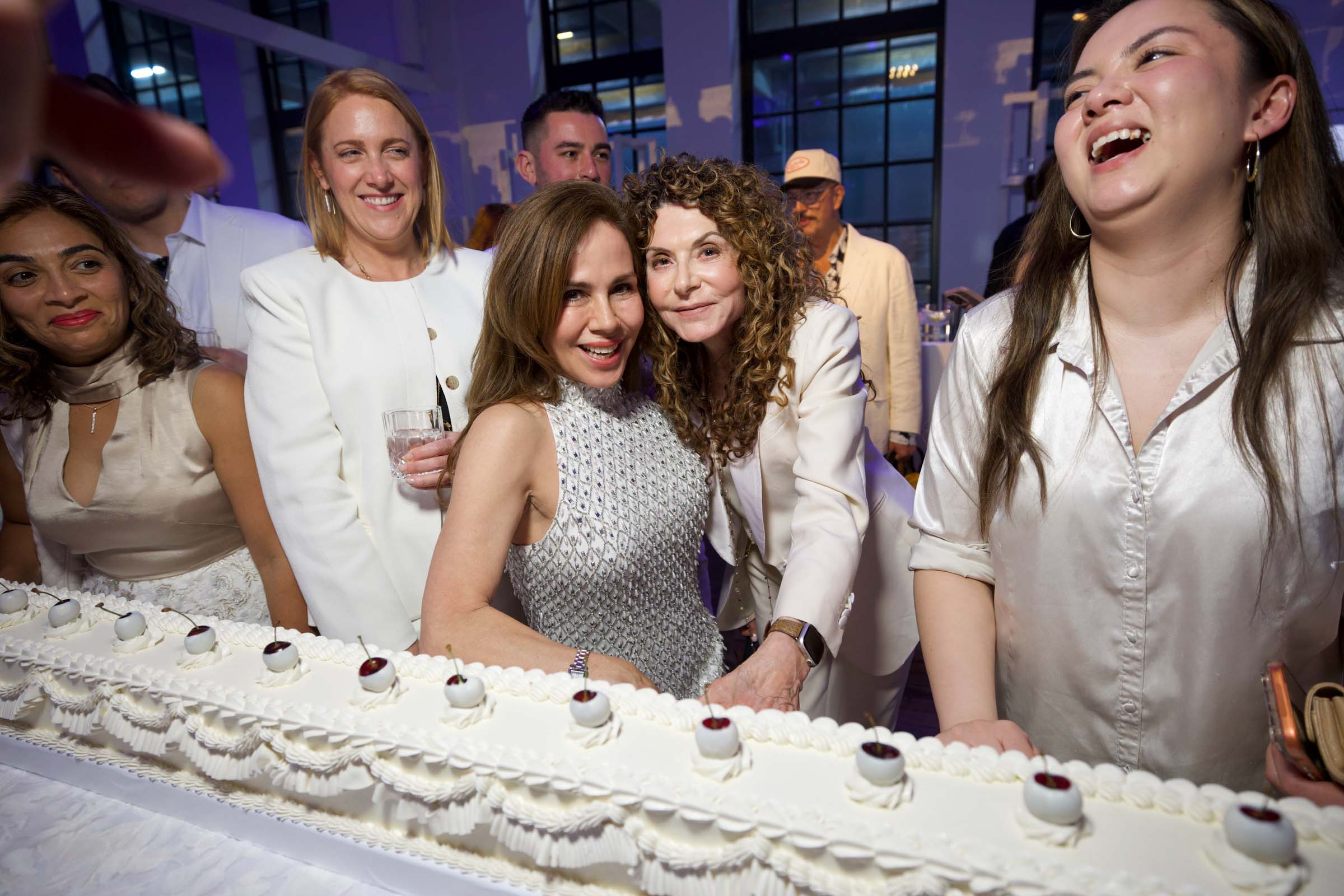 All-white long wedding cake with lambeth piping and white chocolate dipped cherries as decoration