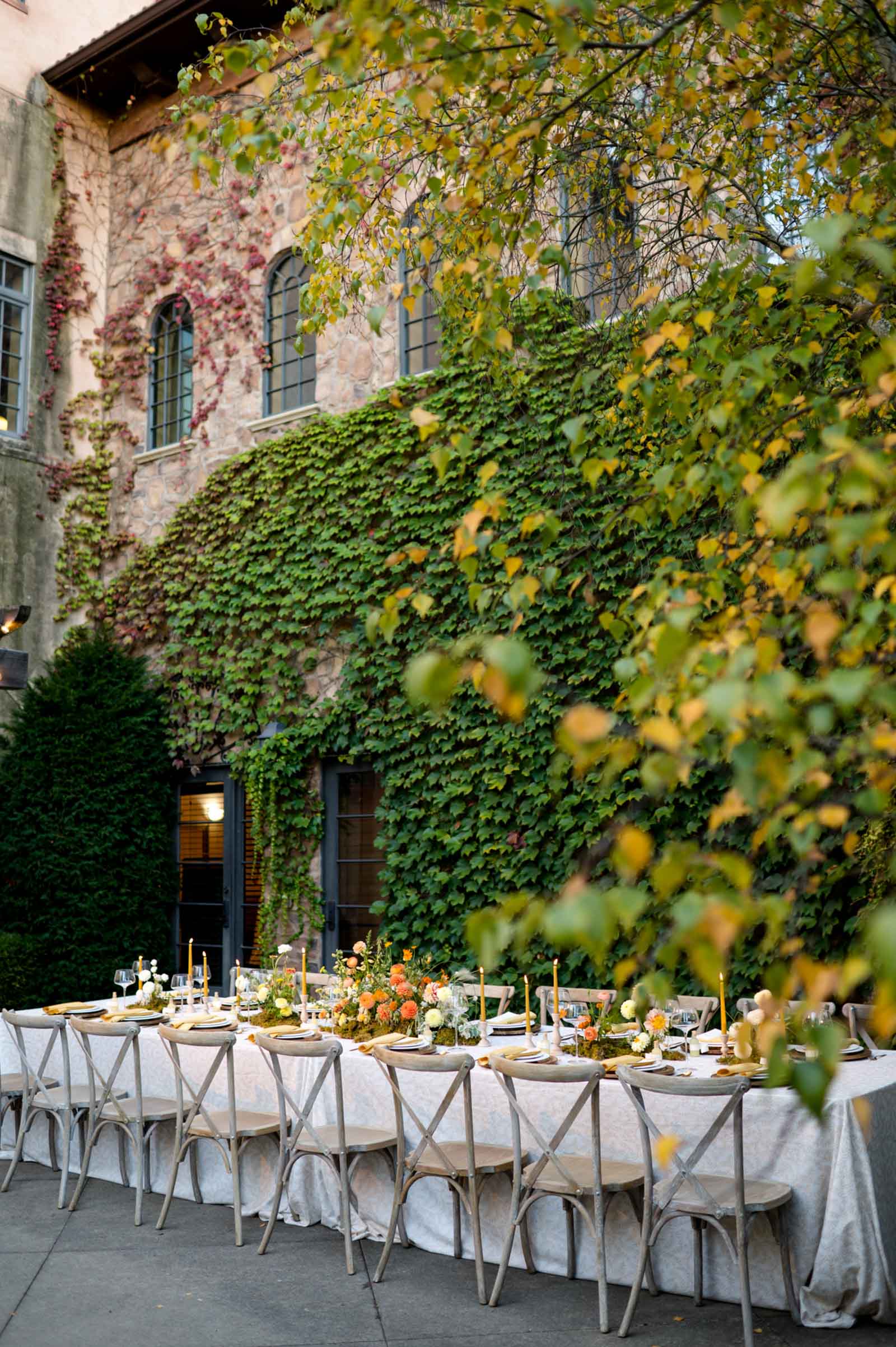 Orange and yellow wedding table decor ideas with candles and low flower centerpieces