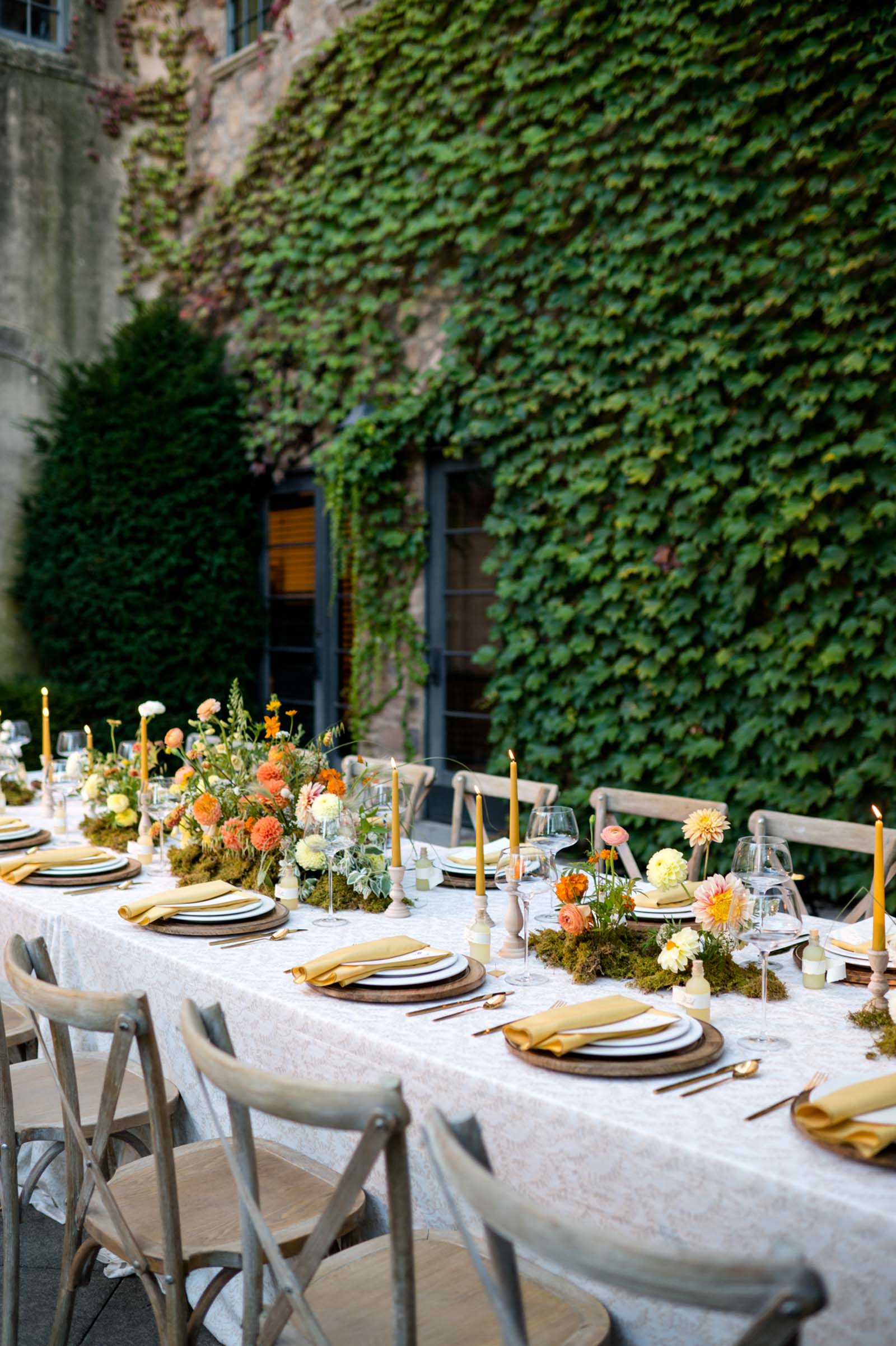 Fall wedding table decor ideas with mustard yellow candlesticks and minimal mossy flower centerpieces