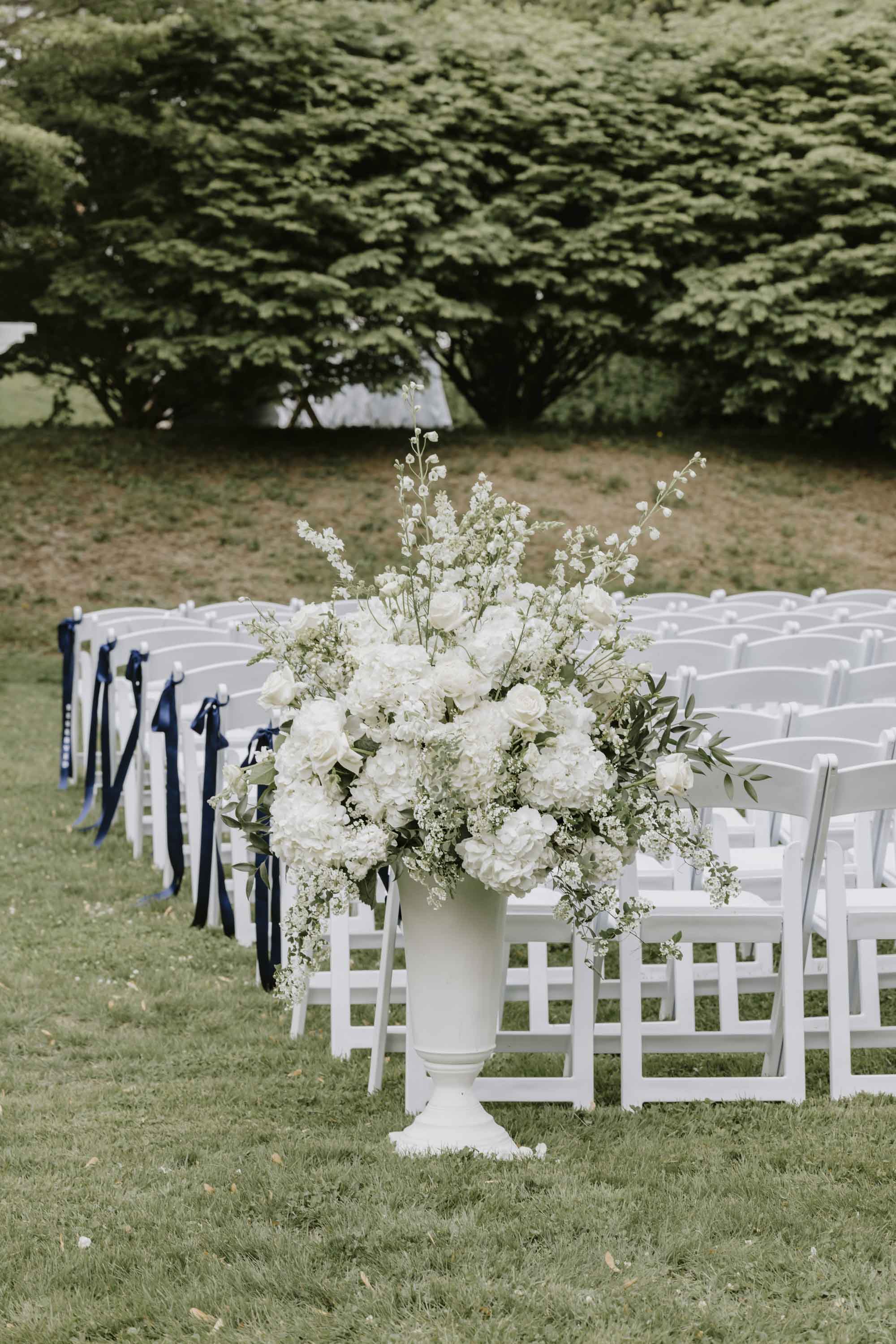 Tall all white wedding flowers for ceremony aisle marker