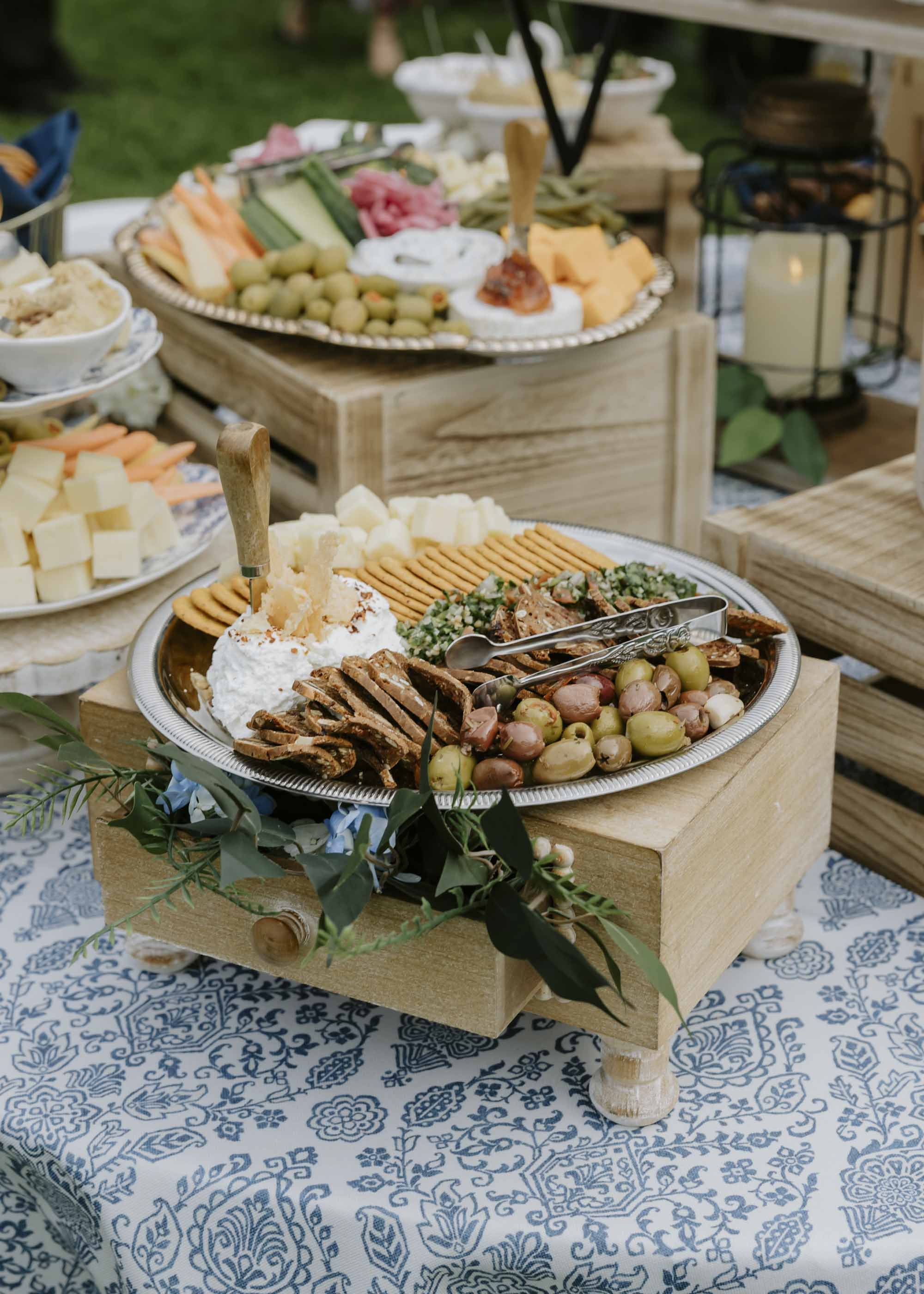 French countryside inspired cocktail hour food spread on French toile tablecloth