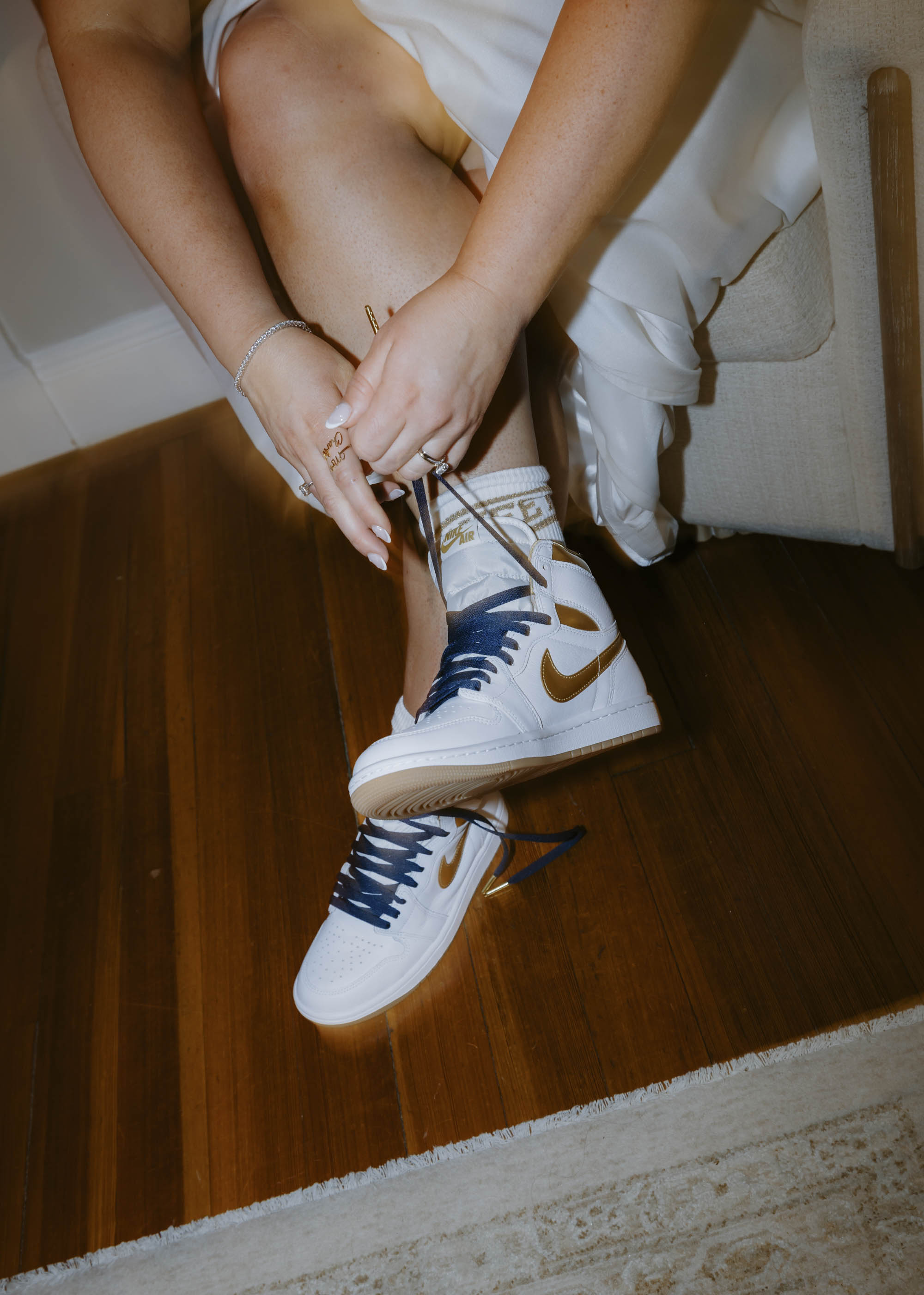 Bride wearing hand painted Nike sneakers for her dance outfit