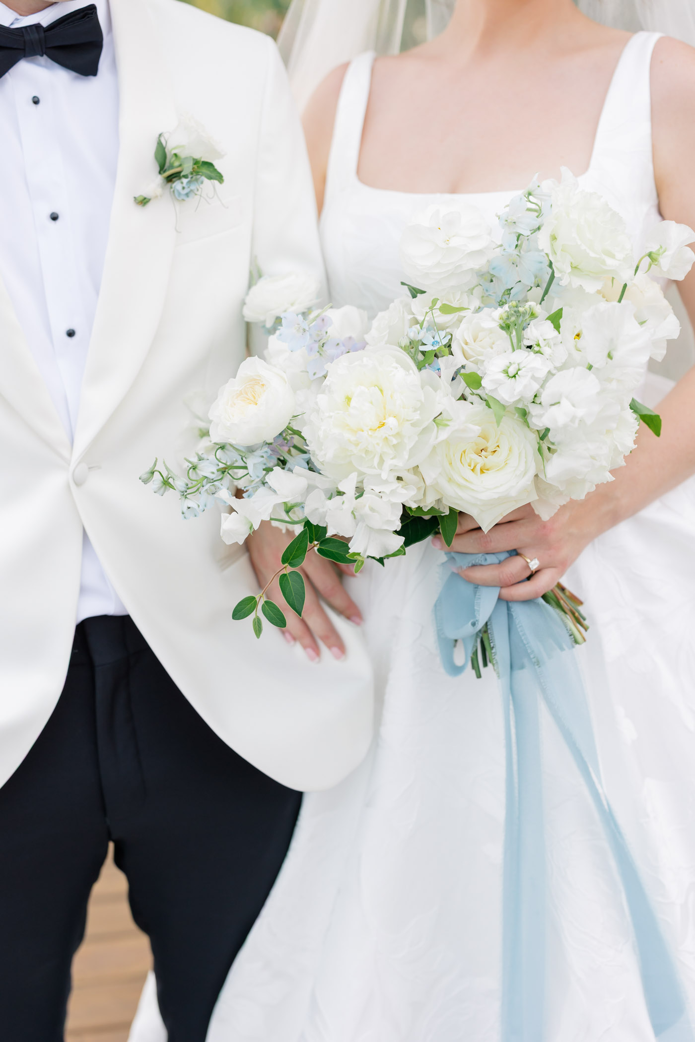 White and blue bridal bouquet with long blue ribbon