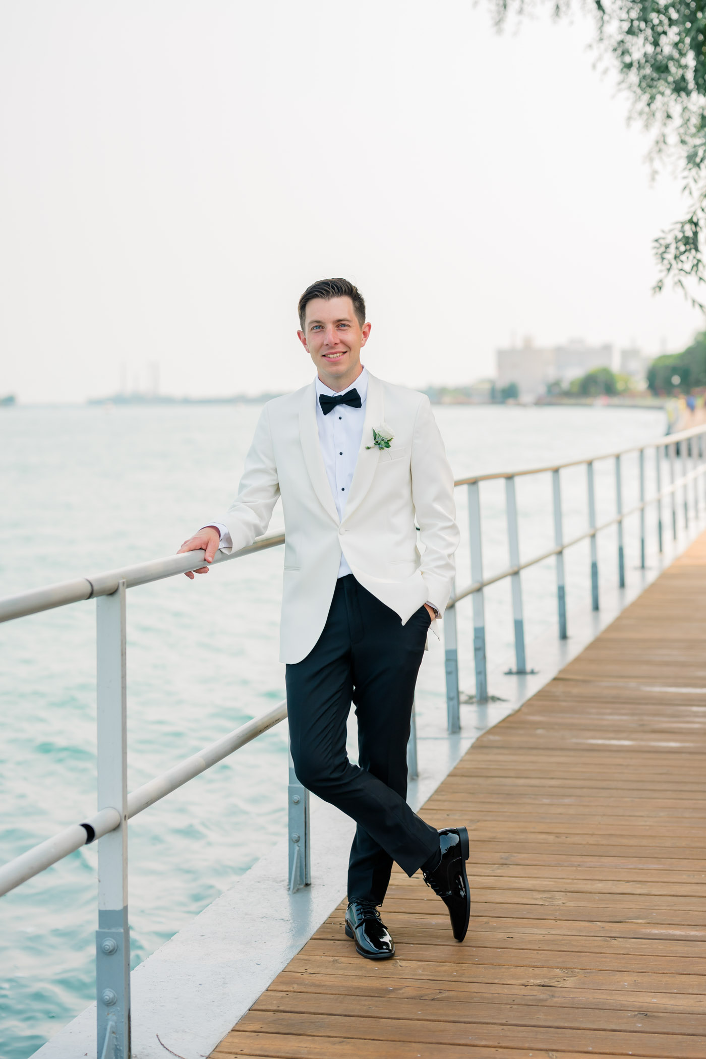 Groom wearing white tuxedo for his classic vintage wedding day
