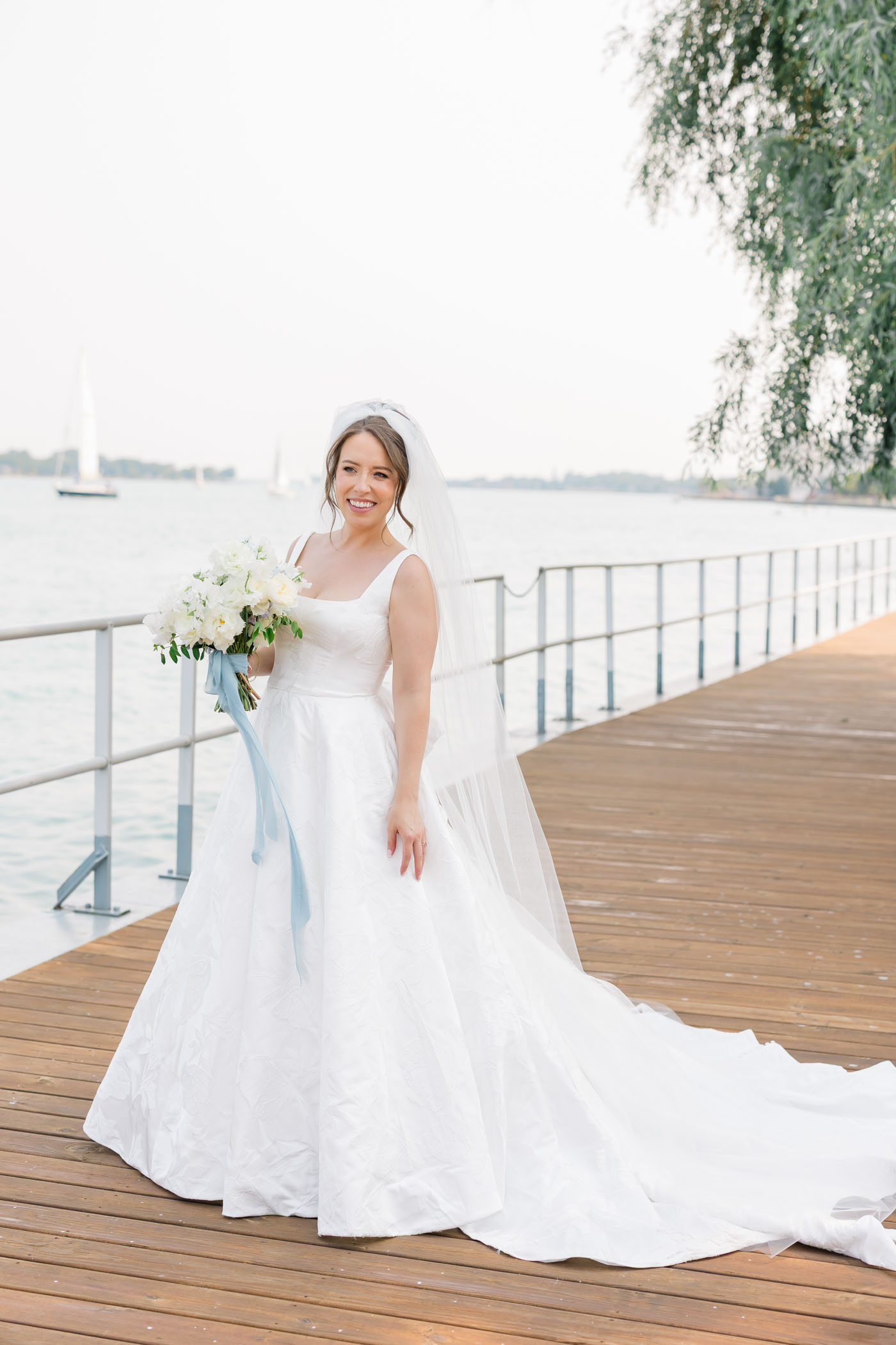 Bride wearing subtle brocade wedding dress with A line skirt and cathedral length veil