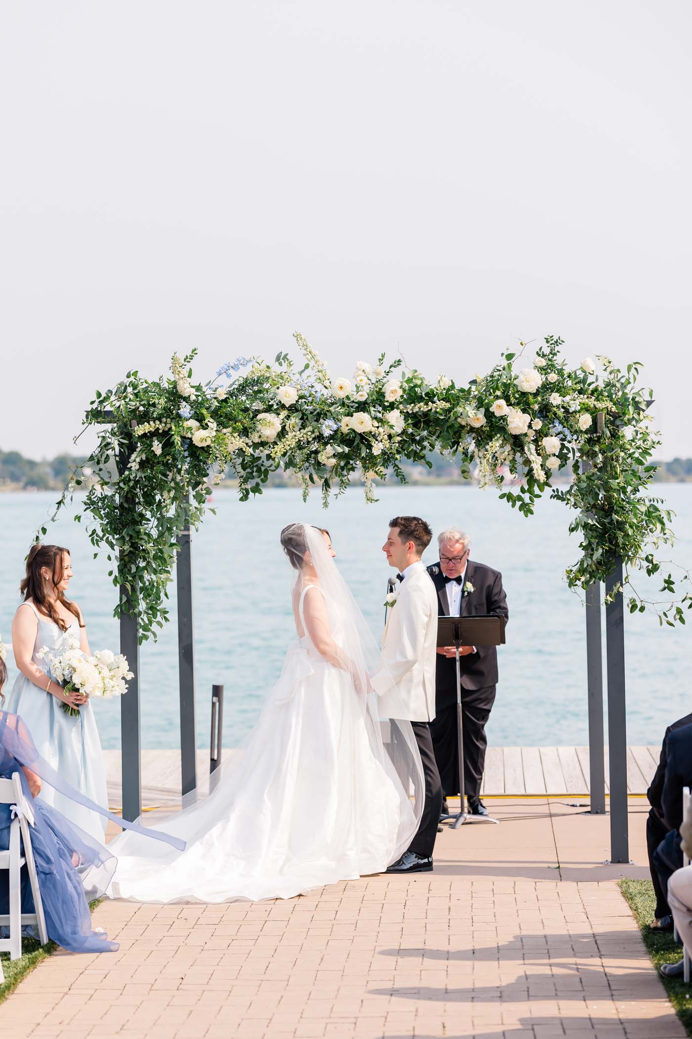 Bride and groom on riverside deck at St Clair Inn for outdoor wedding ceremony