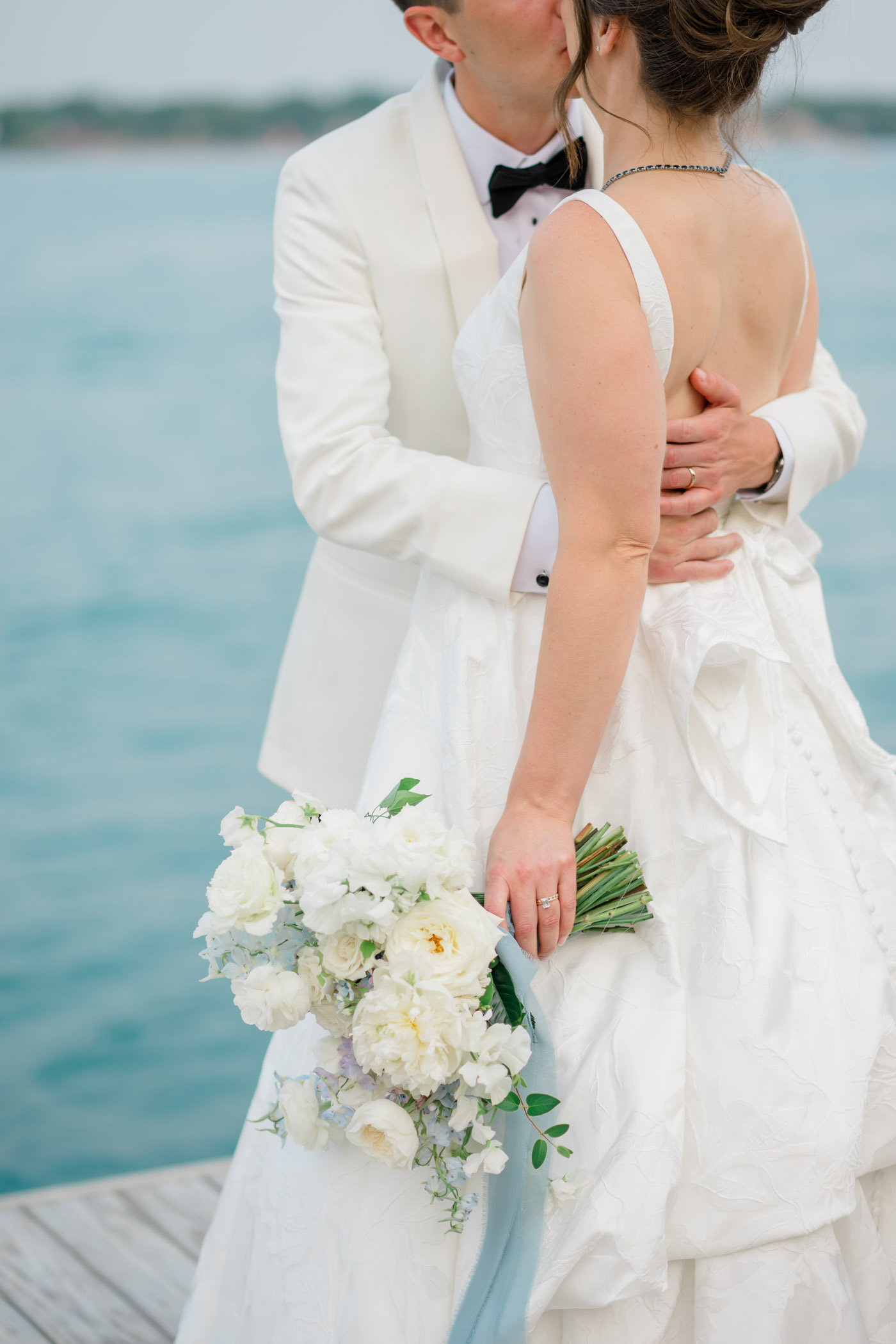 Bride and groom on riverside deck at St Clair Inn in Michigan