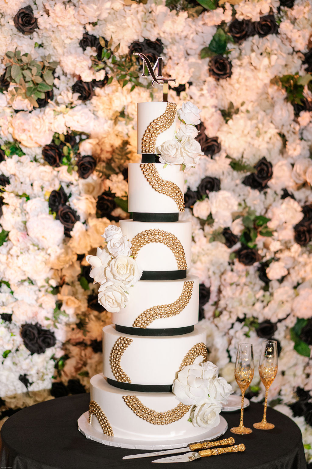 Luxury 6 tiered white and black wedding cake with gold beading design