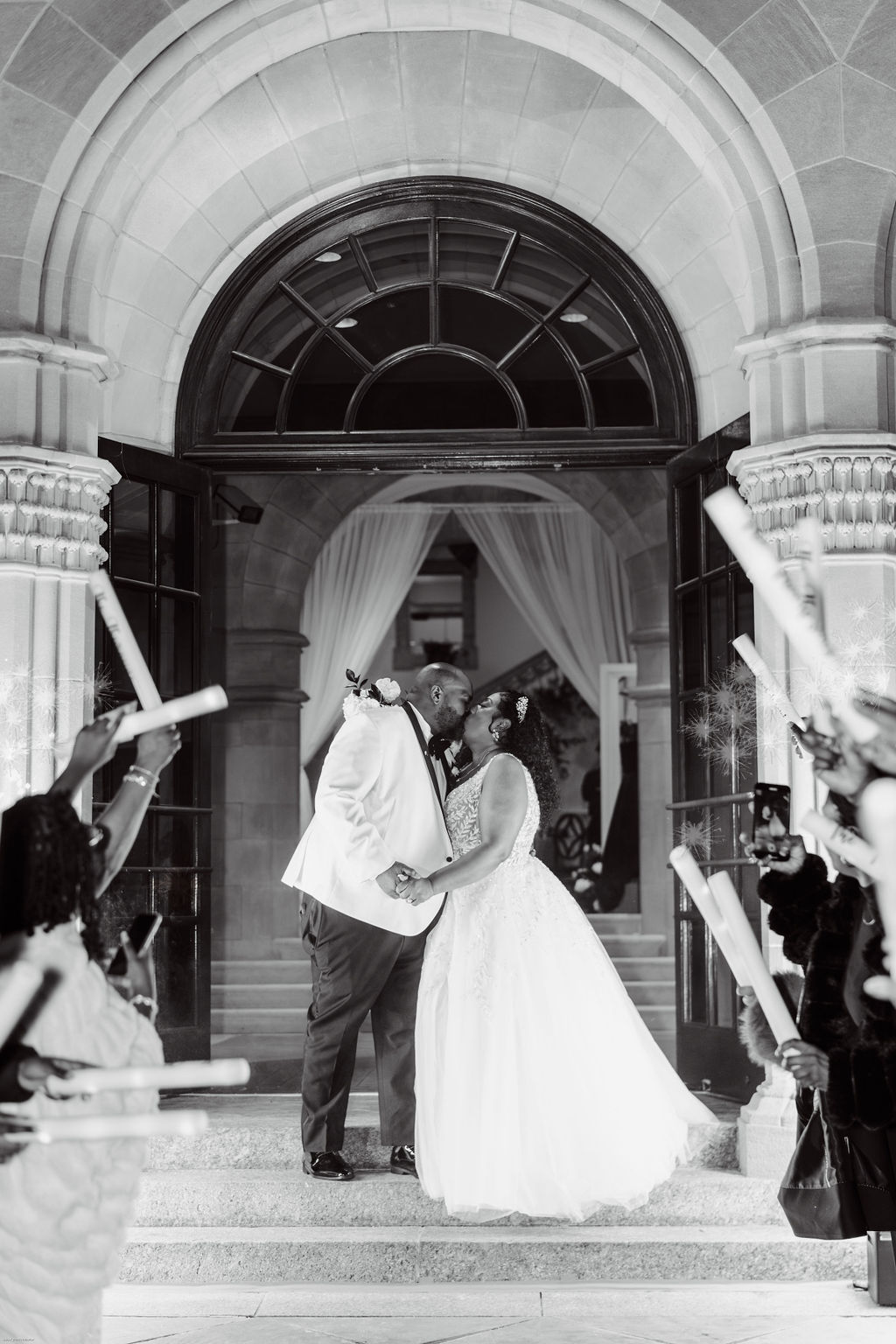 Bride and groom exit their wedding through cold sparklers and glow sticks