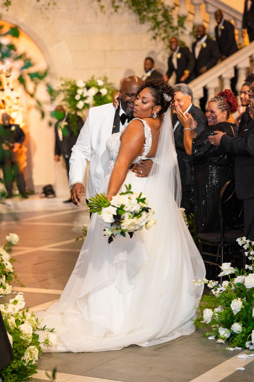 Happy bride and groom share a moment after wedding ceremony in art museum