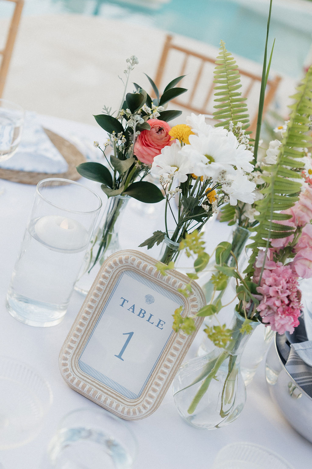 Simple printed wedding table number in a coastal photo frame