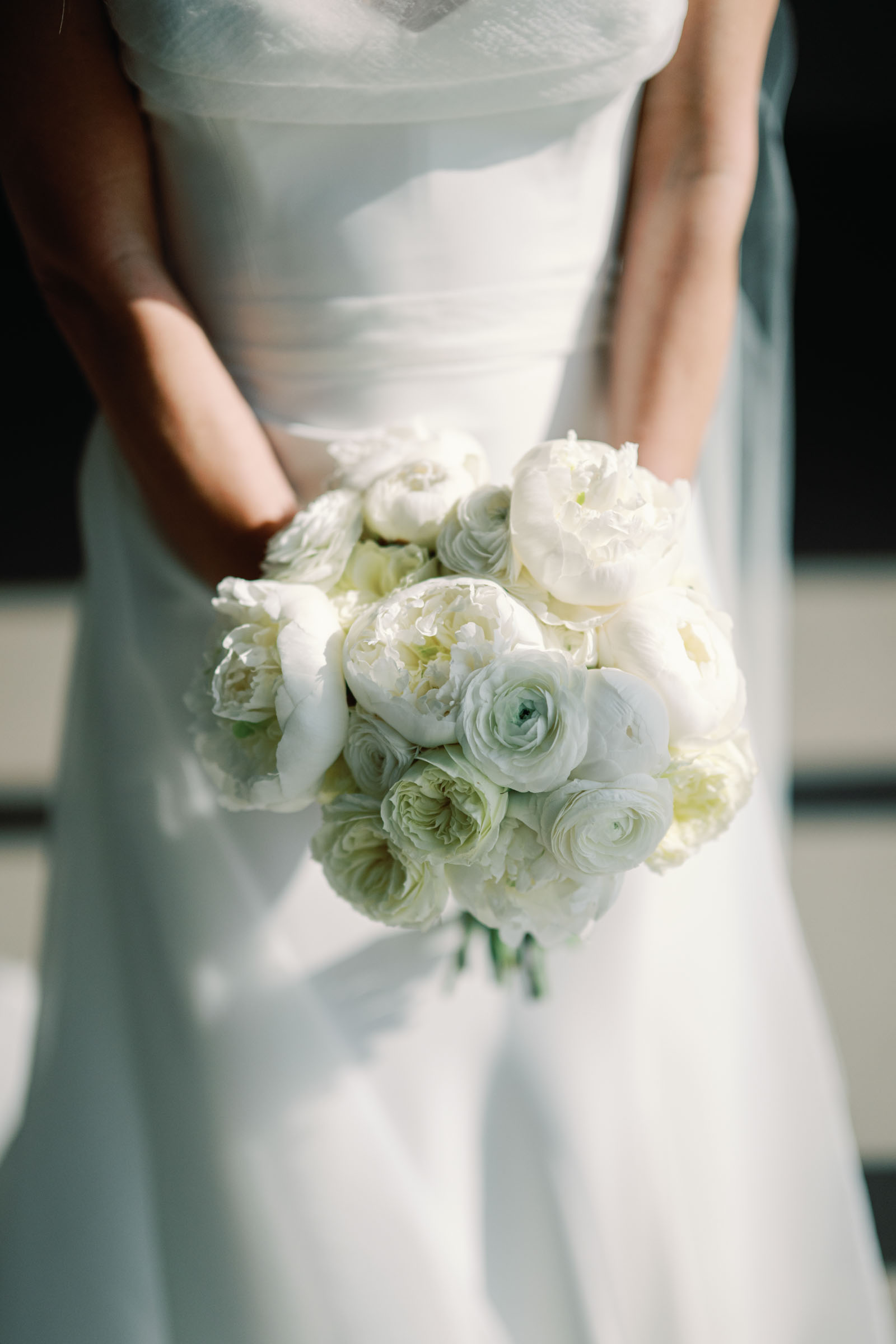 All white wedding bouquet with peonies and ranunculus