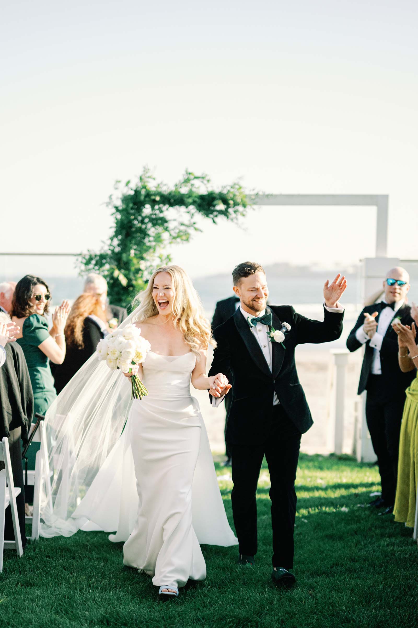Modern Jewish wedding ceremony with a minimalist arch decorated in asymmetrical greenery