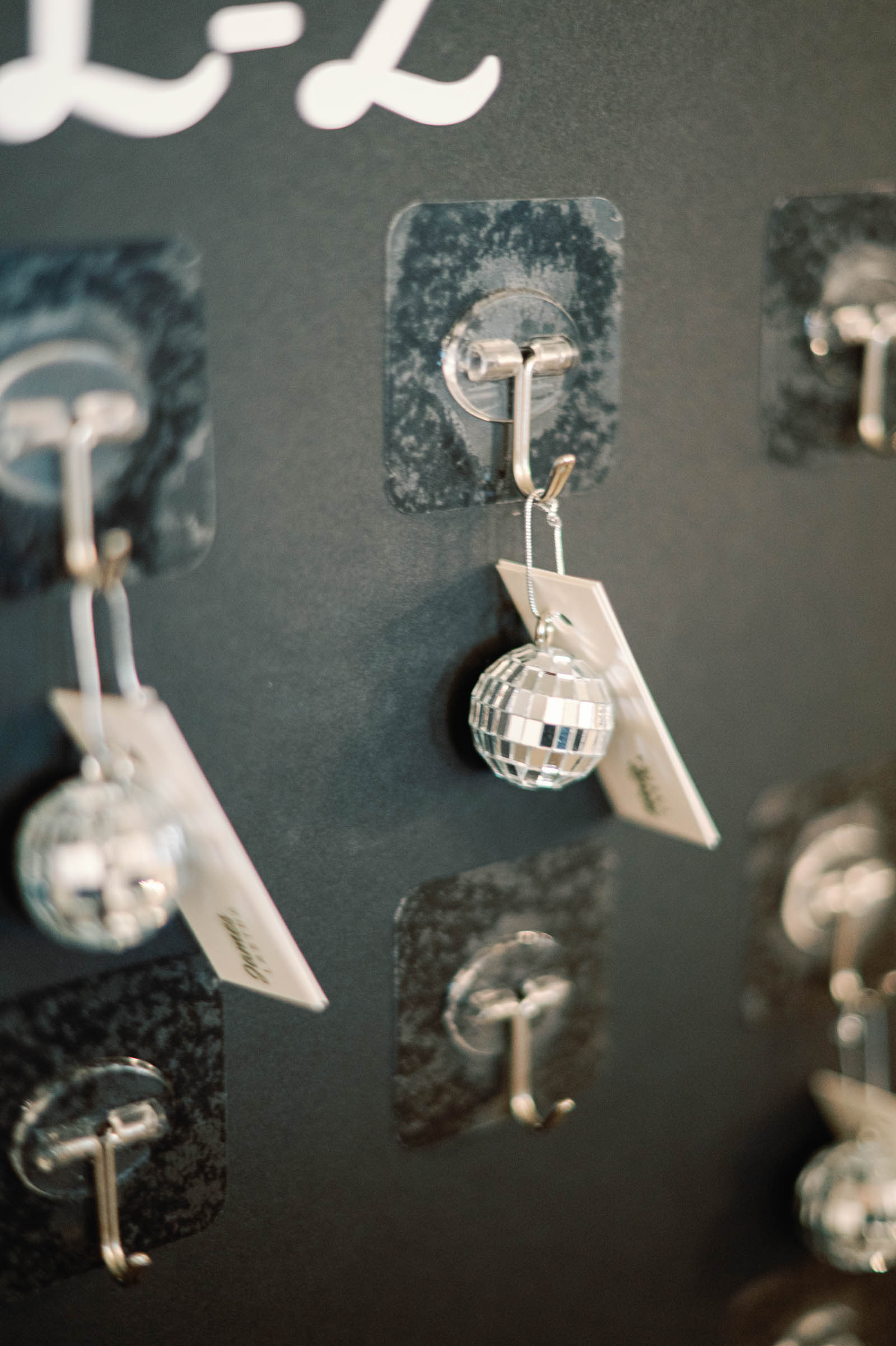 Disco ball wedding escort cards on black seating chart