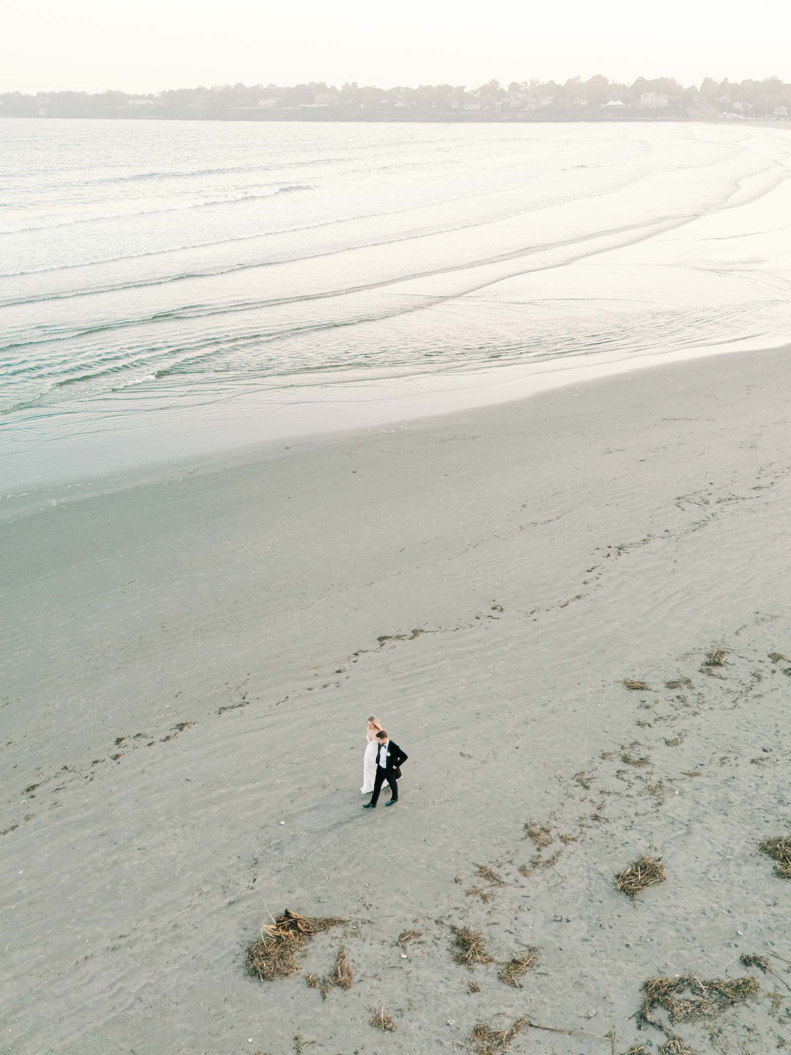 Bride and groom walking on Newport Beach in Rhode Island