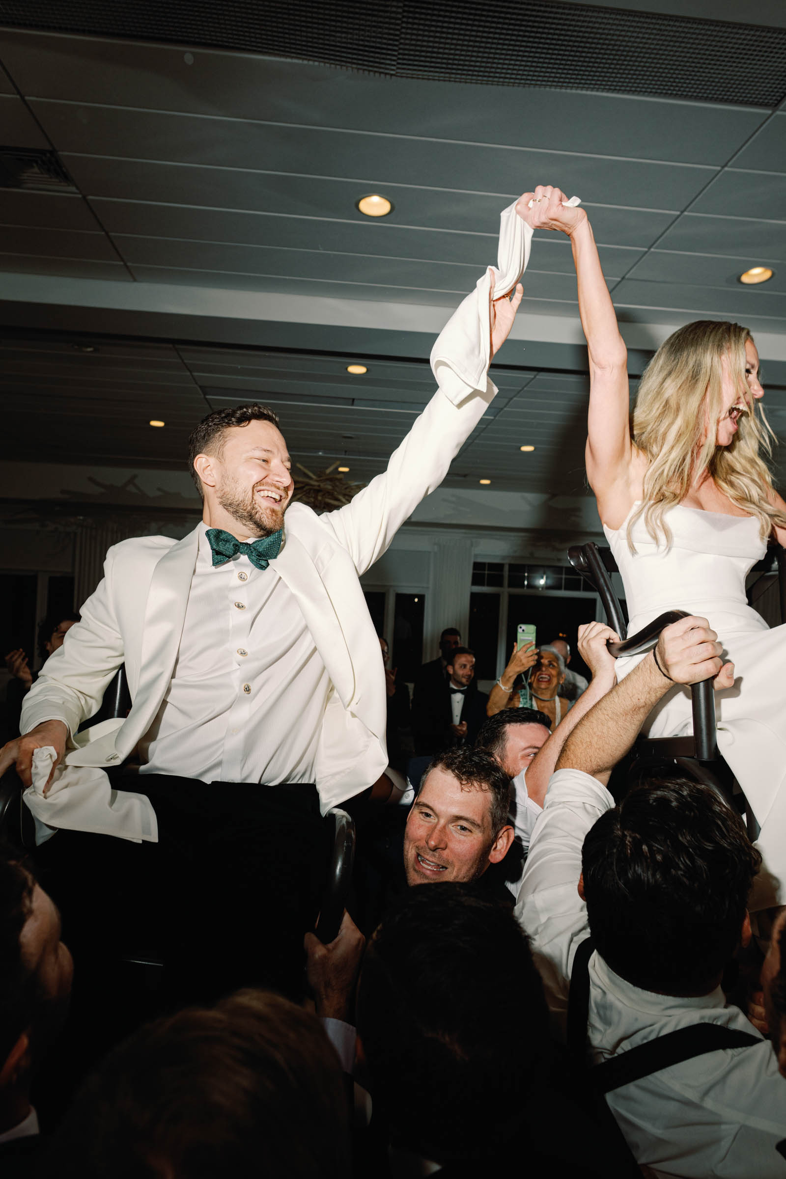 Bride and groom dancing the horah at their beachside wedding reception
