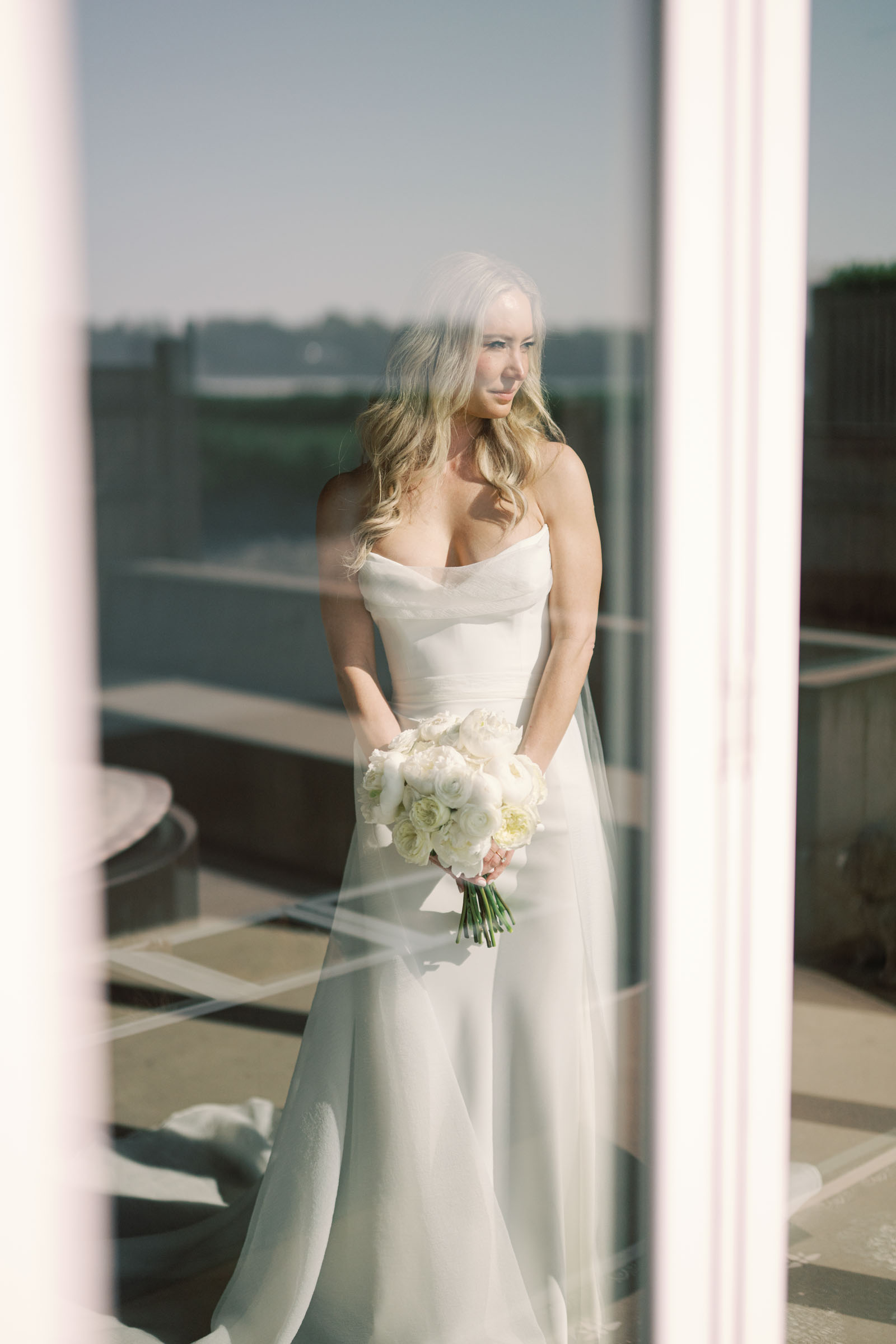 Bride holding an all white wedding bouquet in Newport Rhode Island
