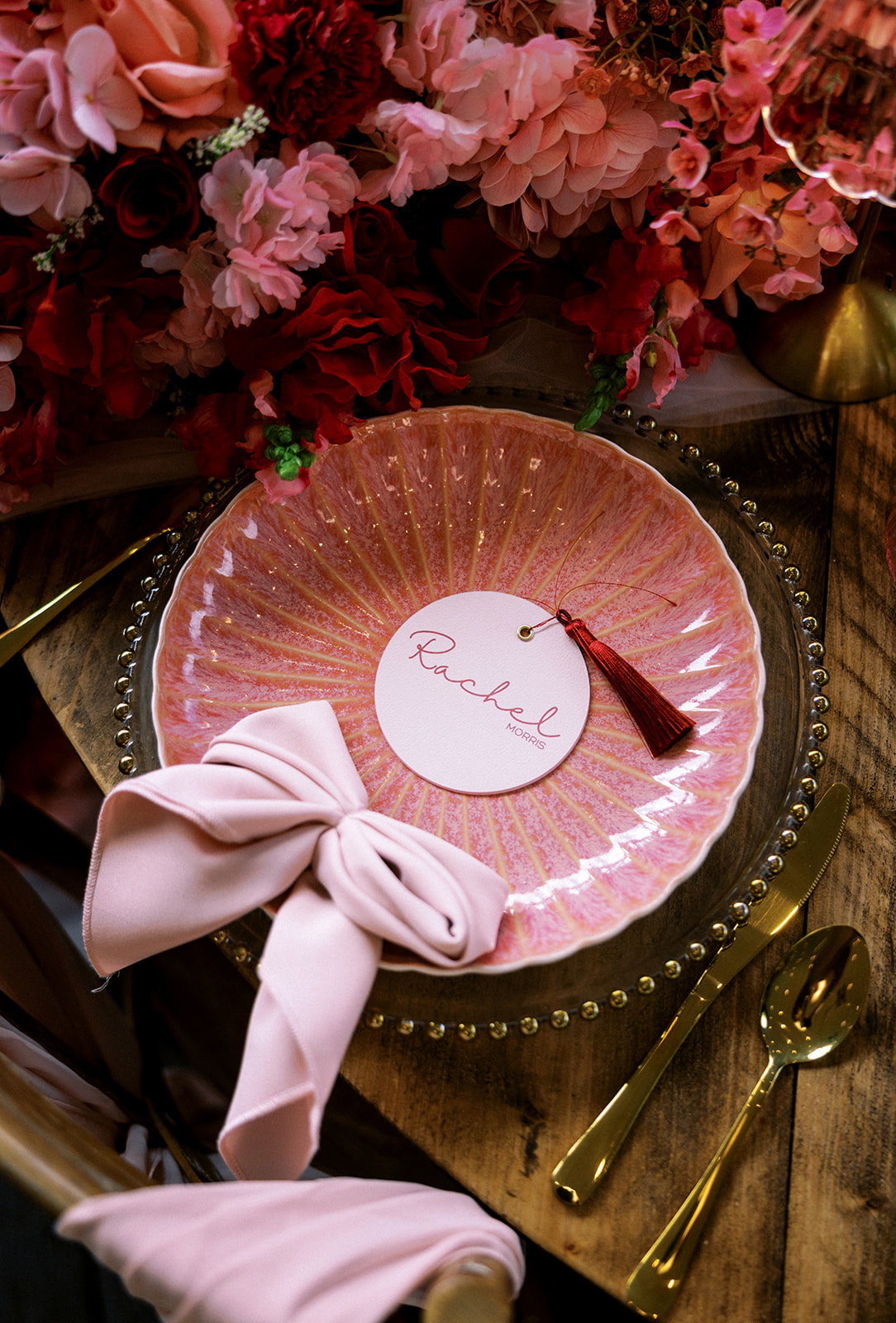 Swivel wedding menus doubling as place cards with a red tassel for a modern wedding reception