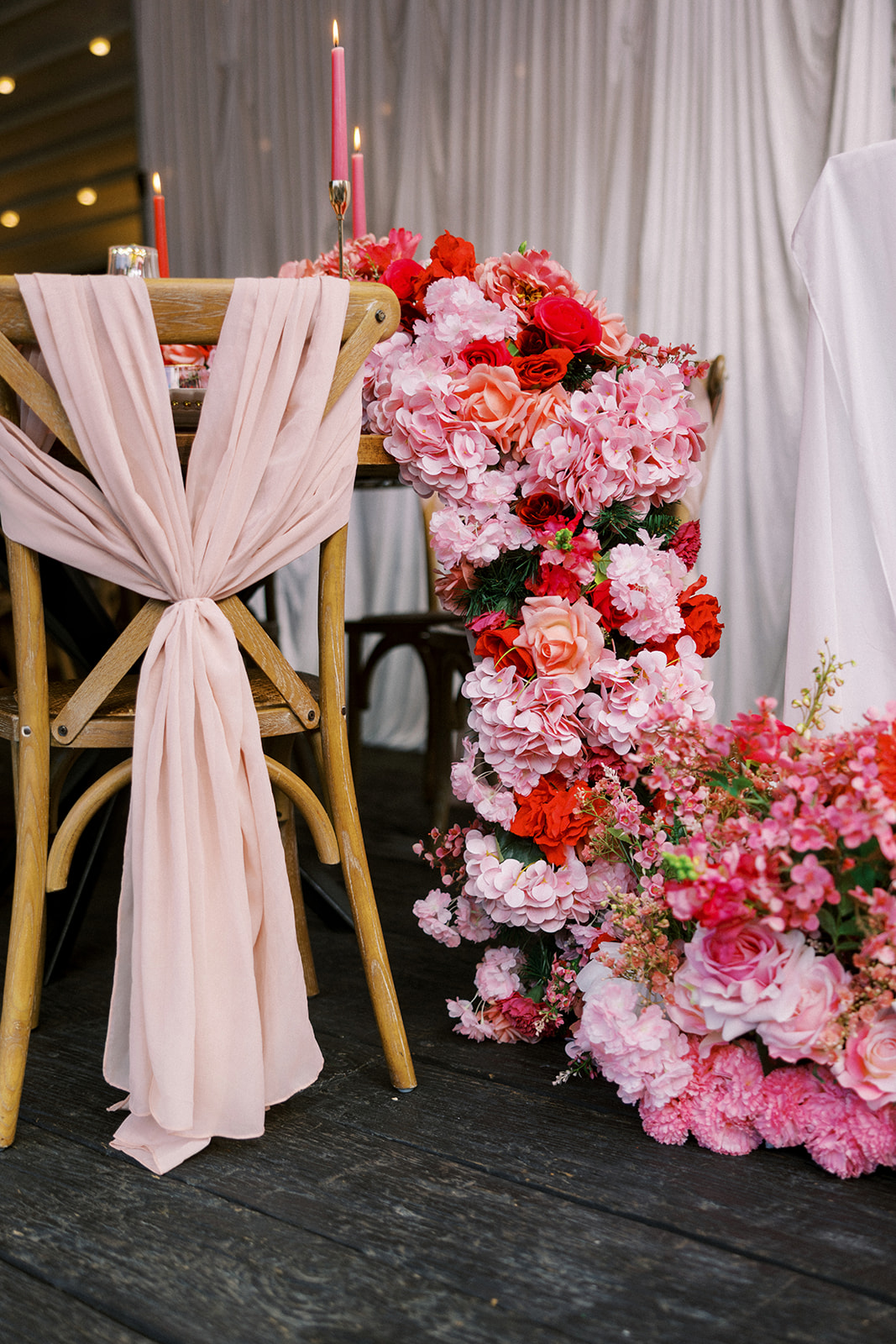Pink and red wedding floral swag garland for unique reception decor look