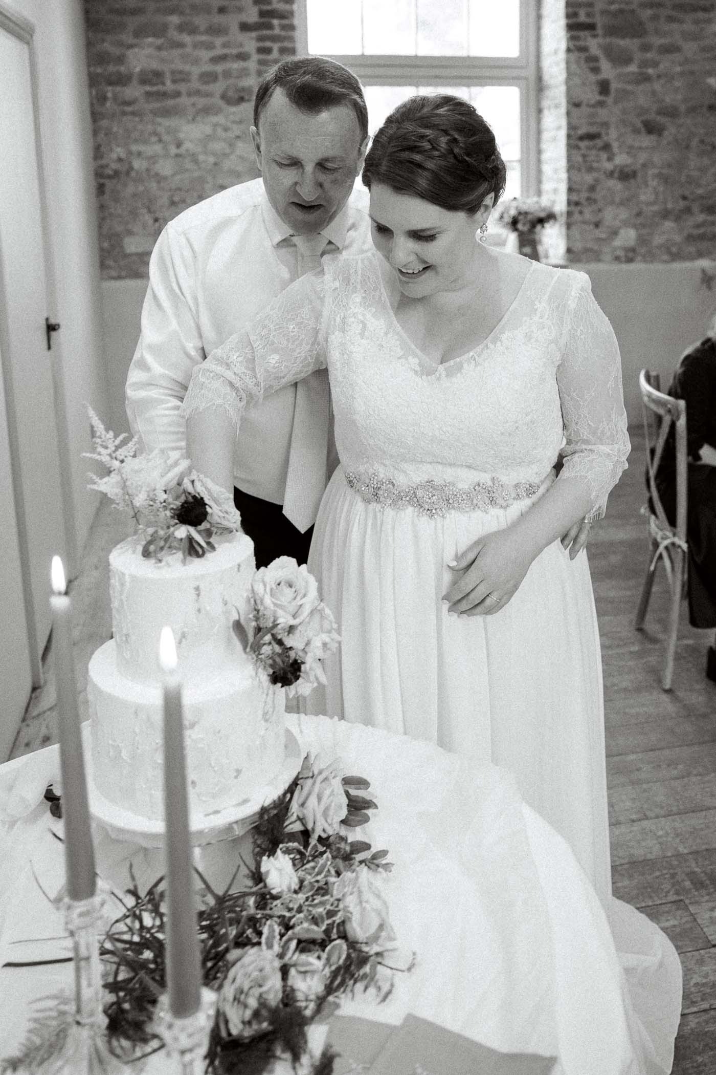 Bride and groom cutting the cake at Walled Garden at Cowdray Estate