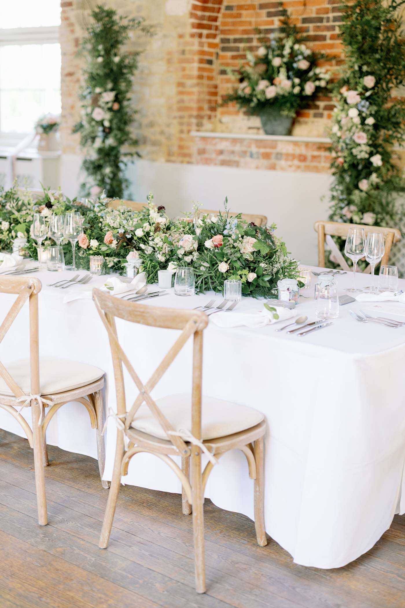 Long wedding reception table with floral table runner