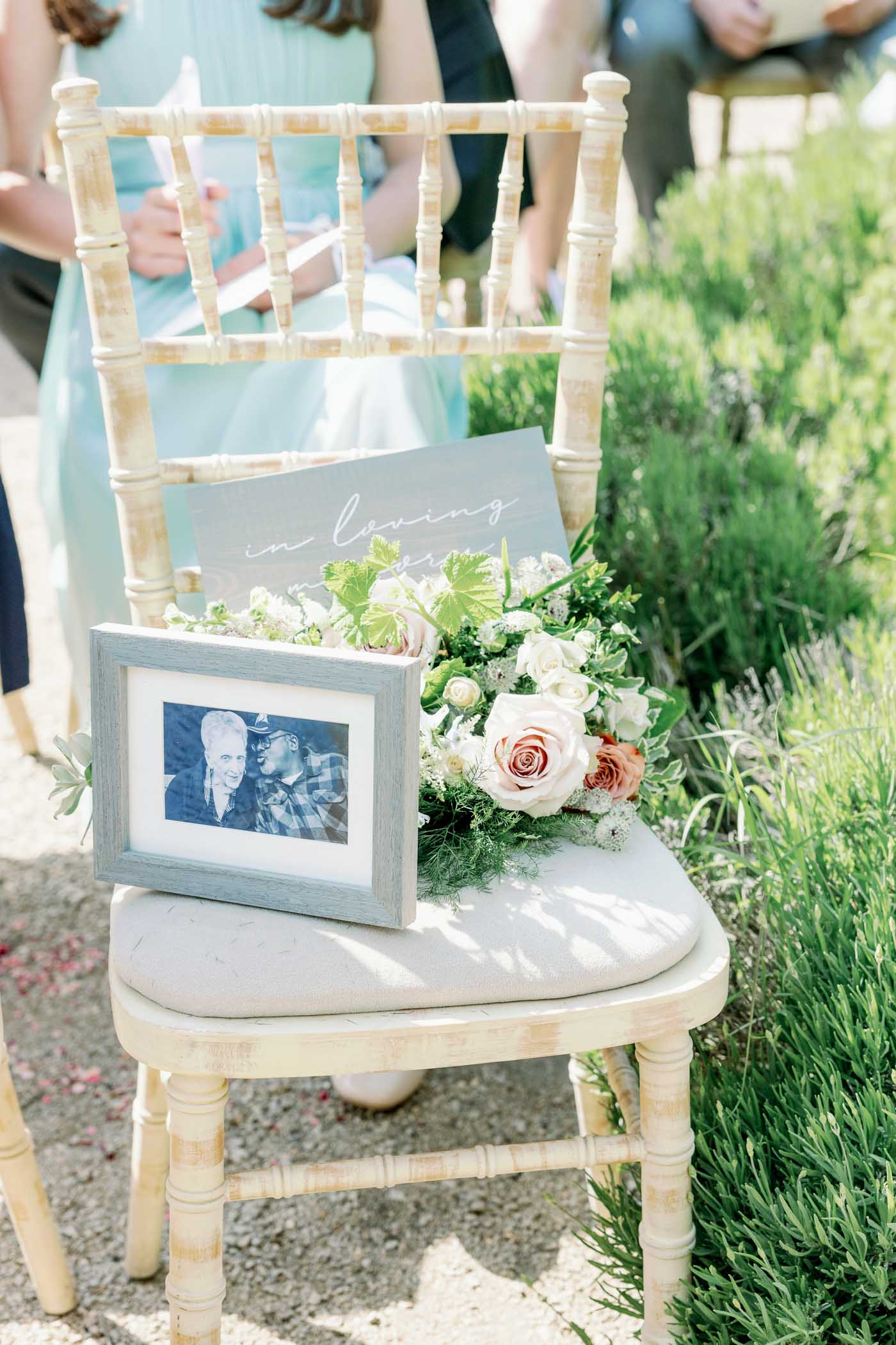 In Loving Memory memorial ceremony chair with small bouquet of flowers