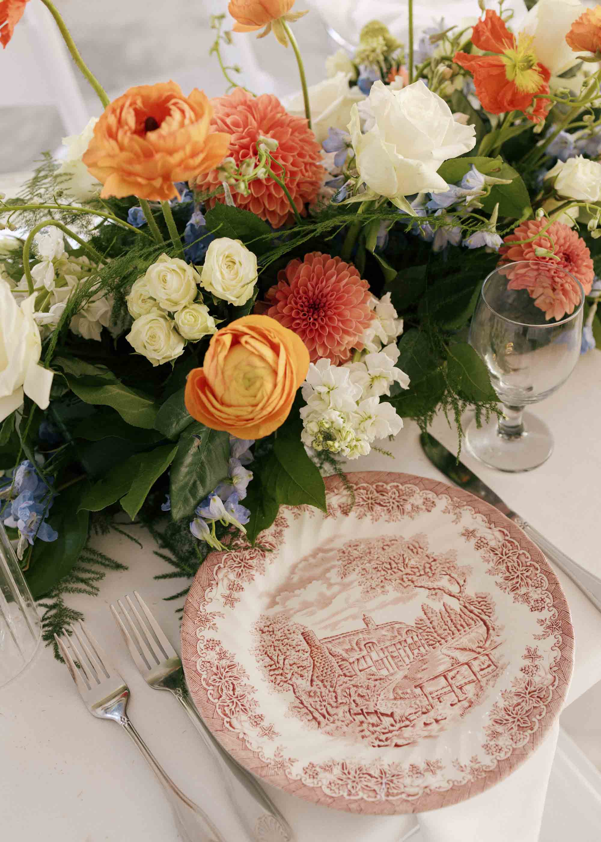 Vintage china plates for curated wedding reception table decor