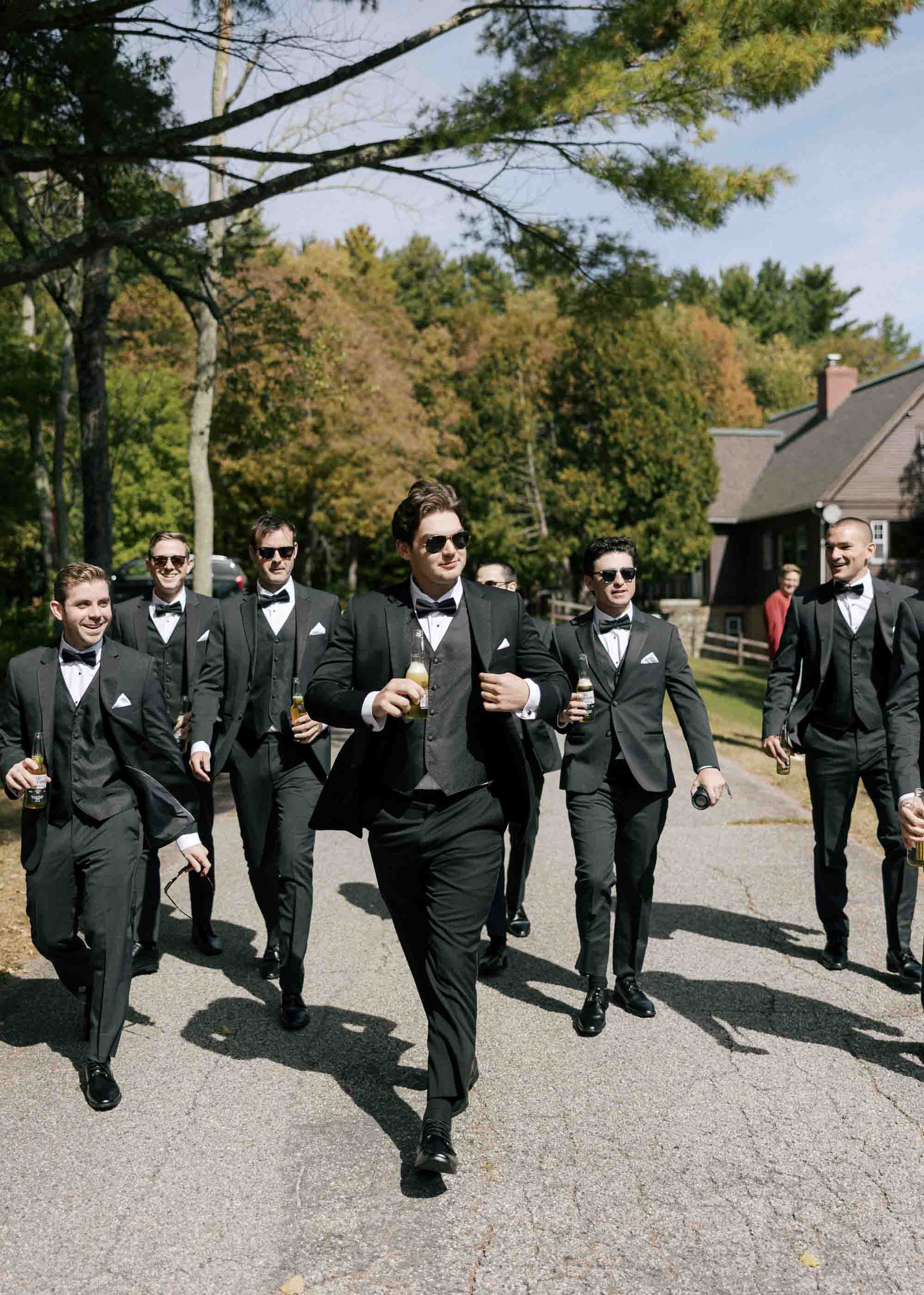 Groom and groomsmen wearing sunglasses and holding drinks