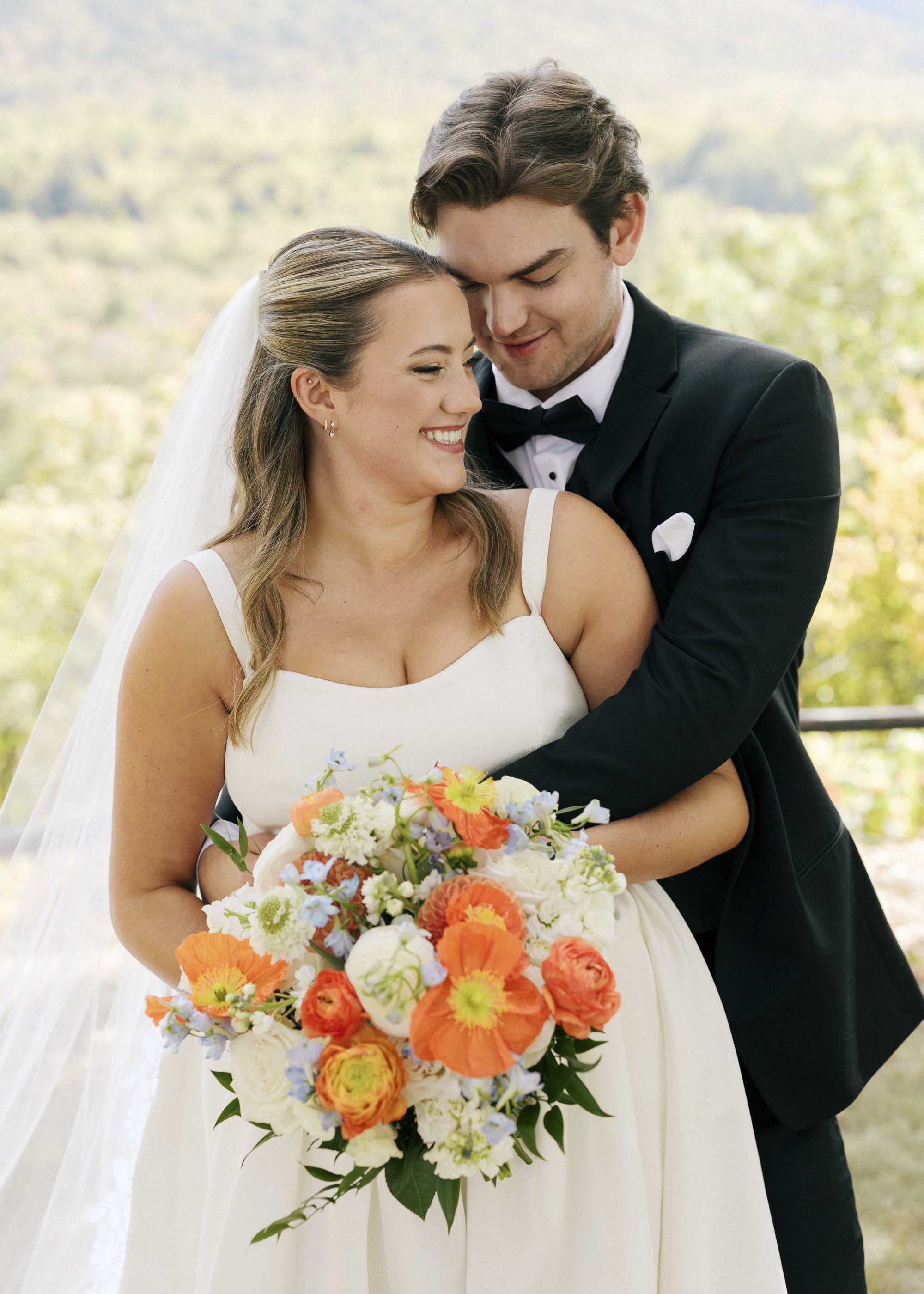 Bride wearing a wedding dress with sweetheart neckline and basque waist bodice and thick straps
