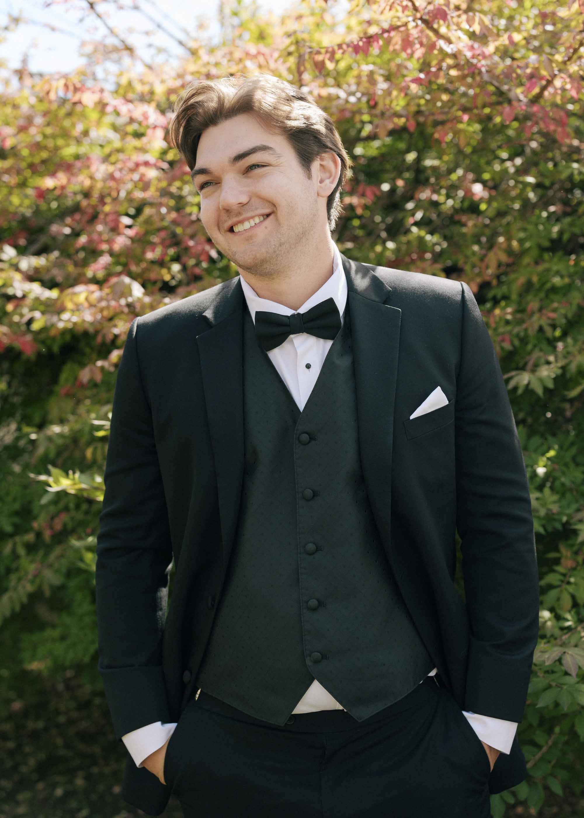 Groom wearing classic three piece black suit for wedding