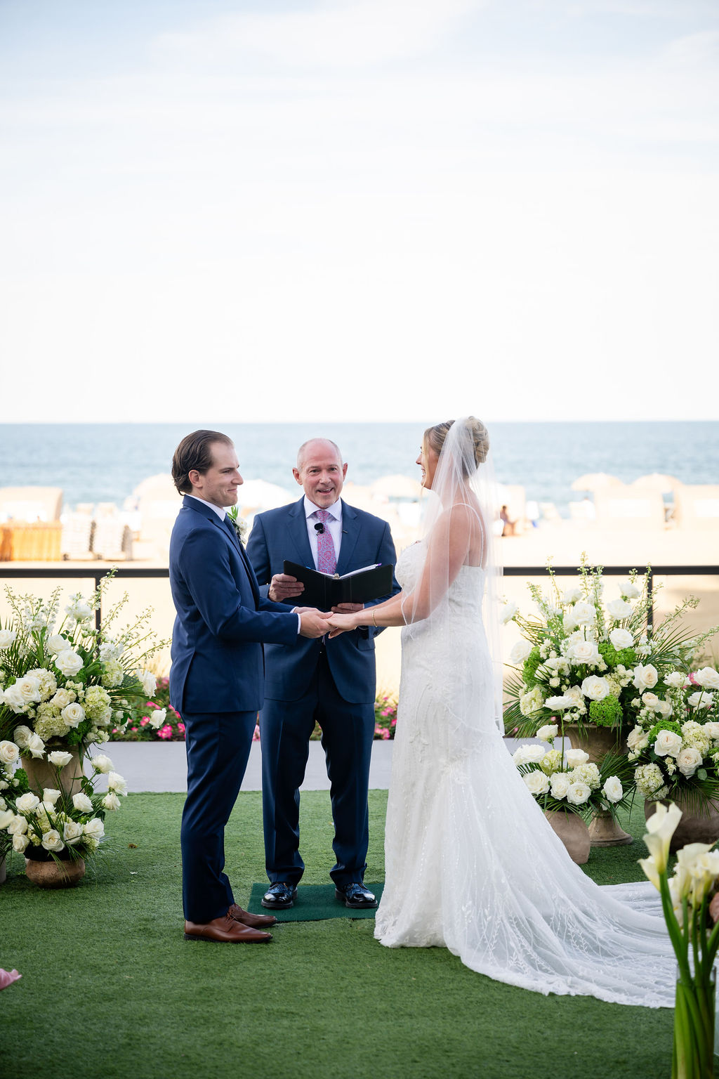 Bride and groom exchanging vows during their beach wedding in Virginia Beach